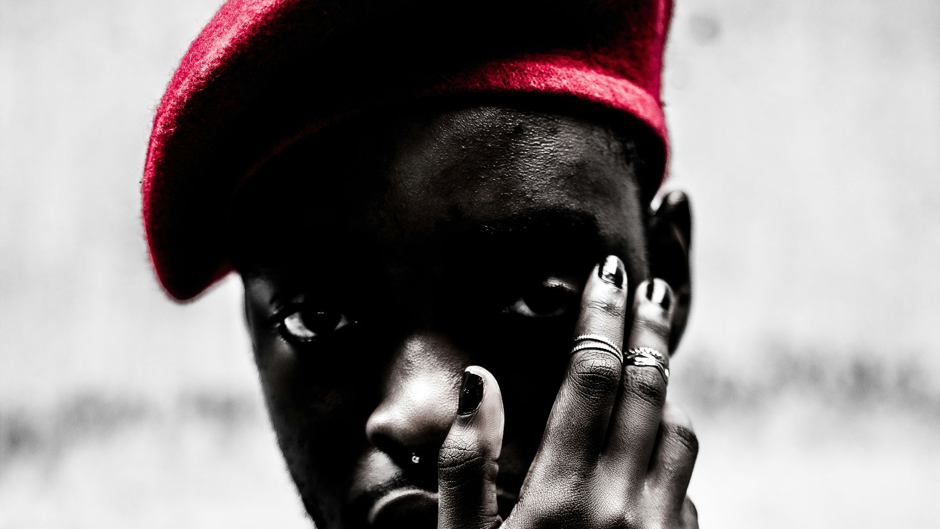 selective color photography of man with red cap