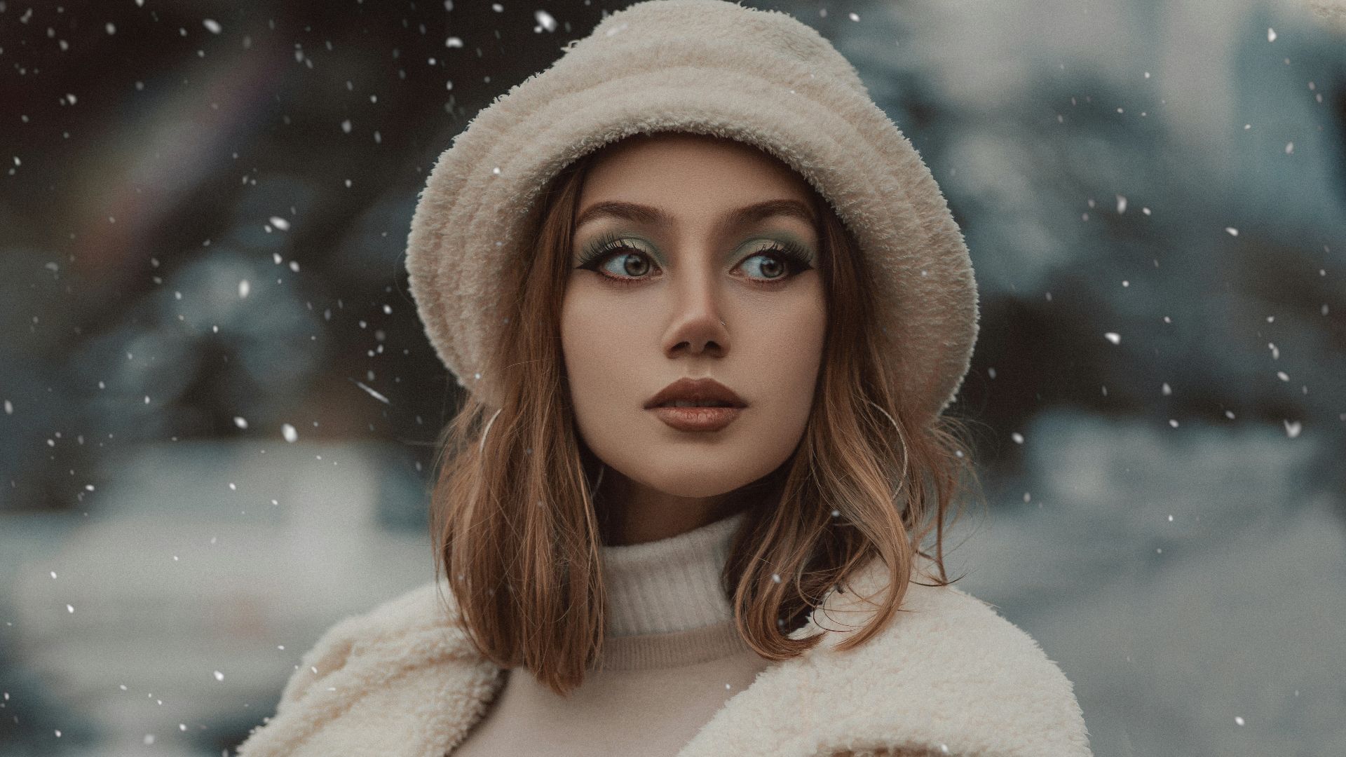 a woman wearing a white coat and hat