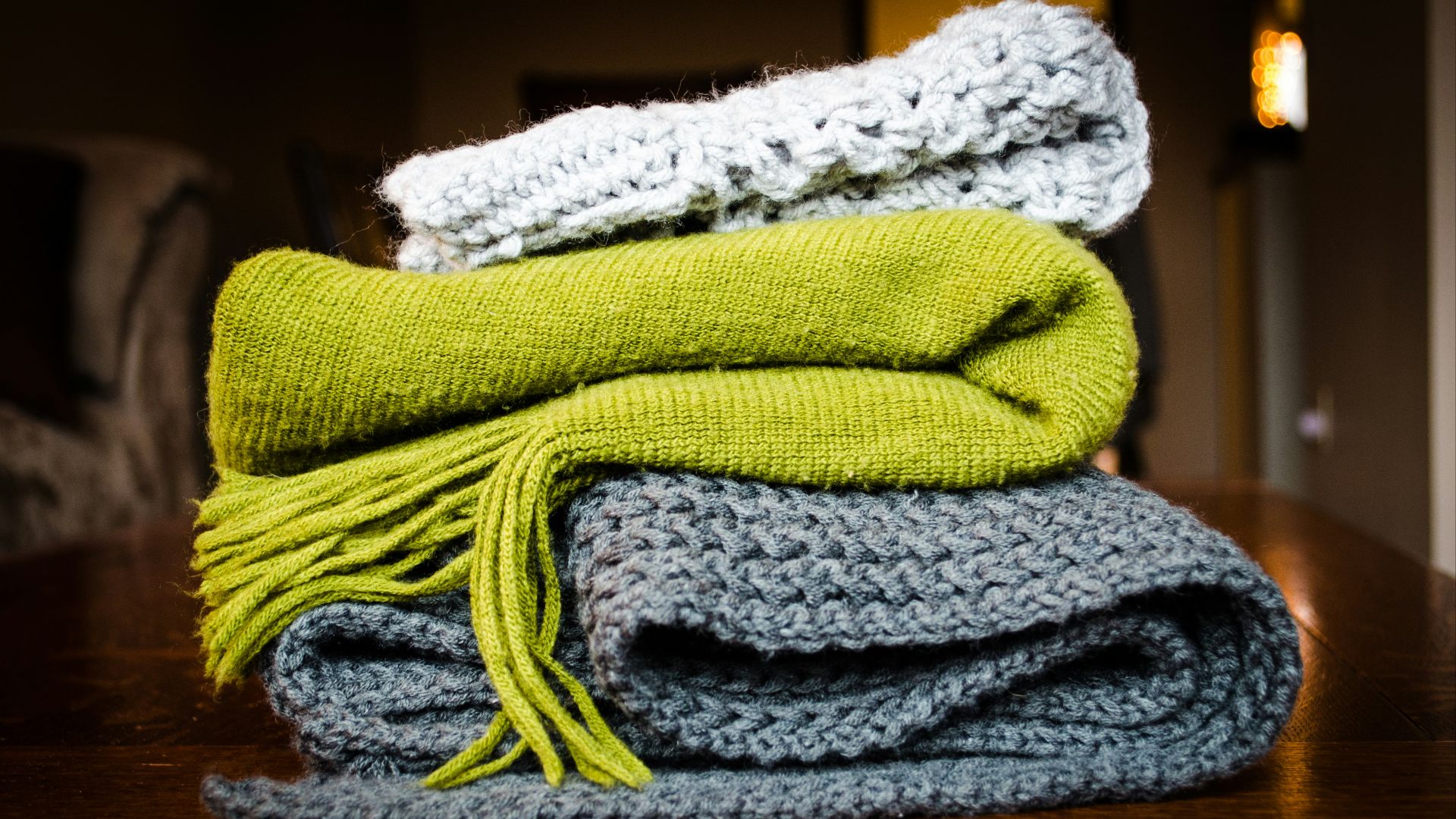 three gray, green, and white scarf on top of table