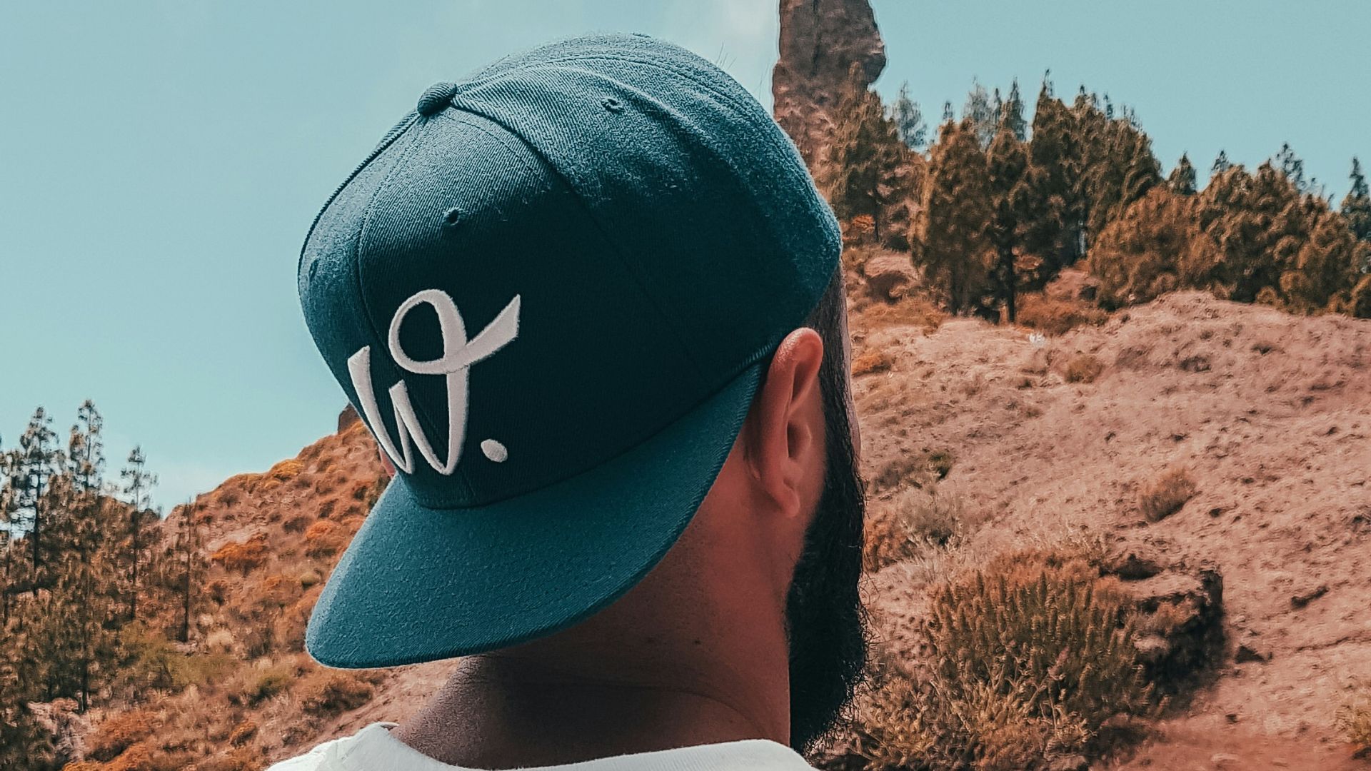 man wearing white Patagonia crew-neck T-shirt and blue cap