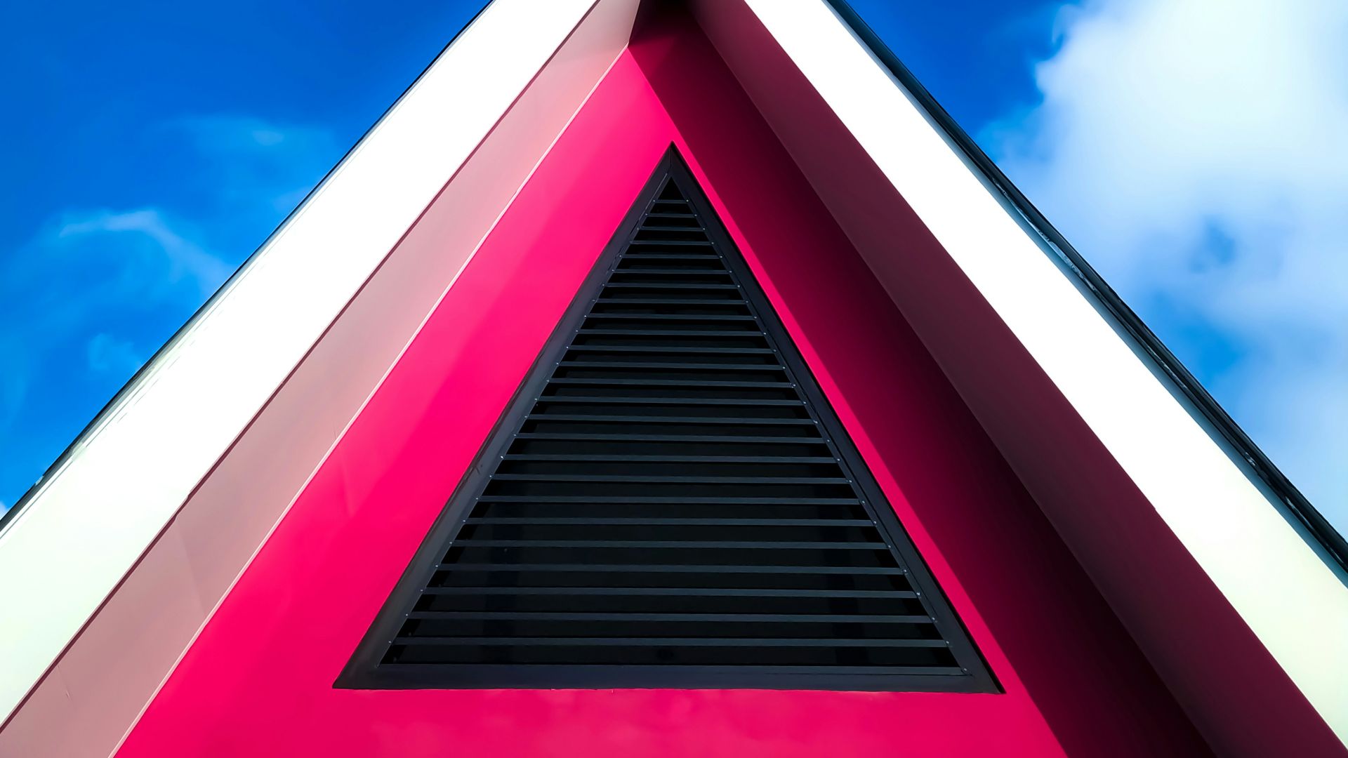 red and white concrete building under blue sky during daytime