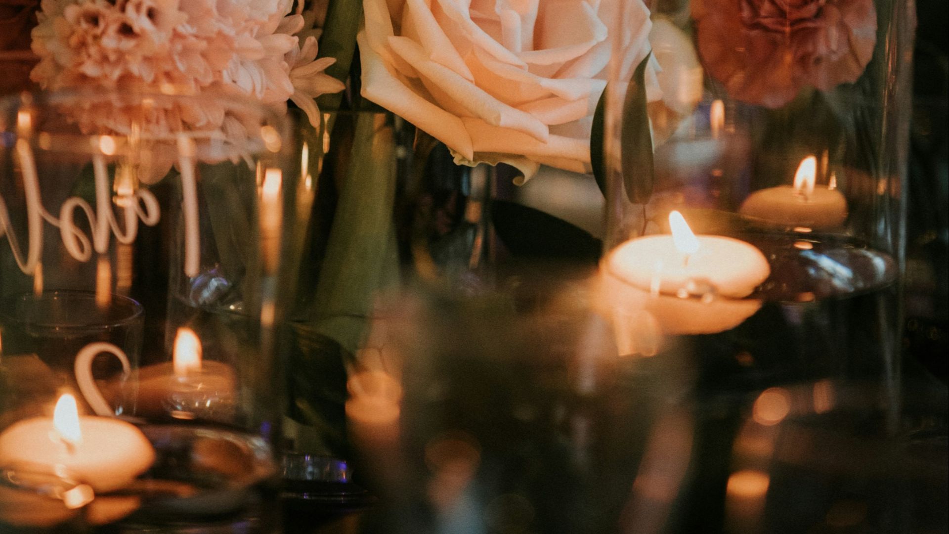 white roses in clear glass vase