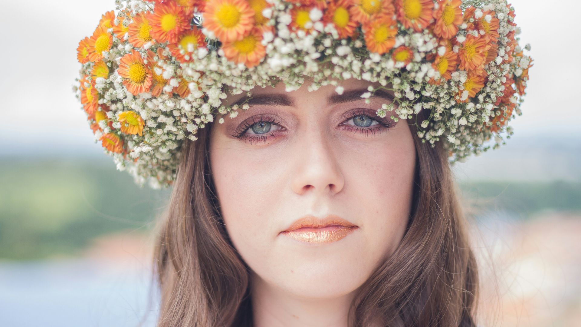 woman with orange and white floral headdress