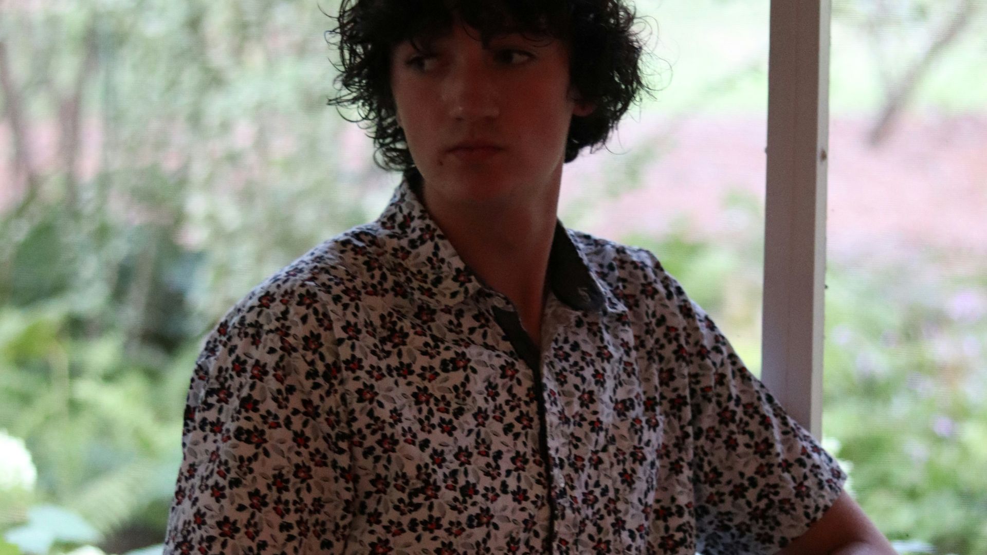 a man sitting at a table in front of a window