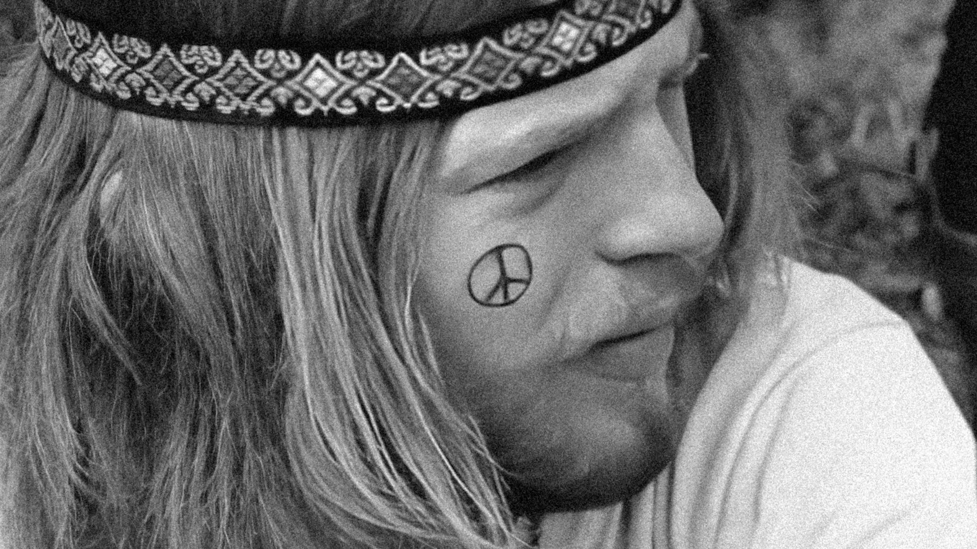 a man with a peace sign tattoo on his forehead
