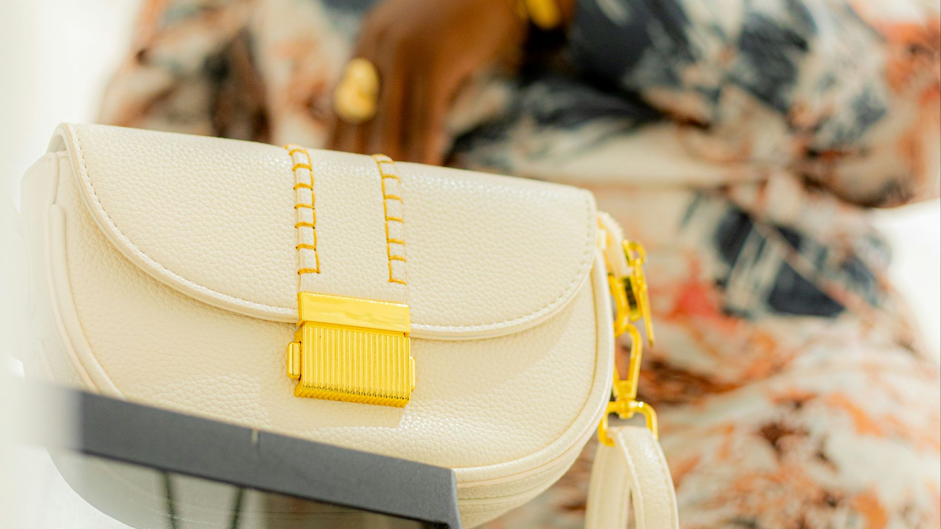 A stylish woman poses with her handbag.