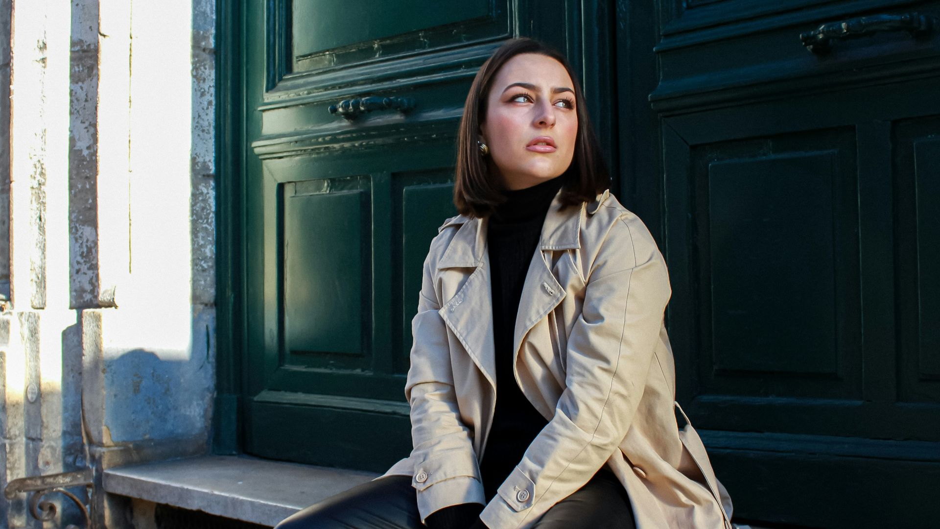 a woman sitting on the steps of a building