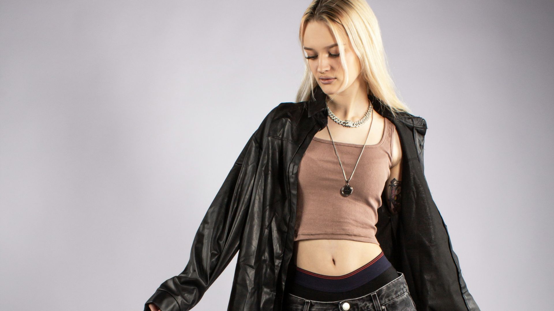 a woman in a crop top and wide jeans