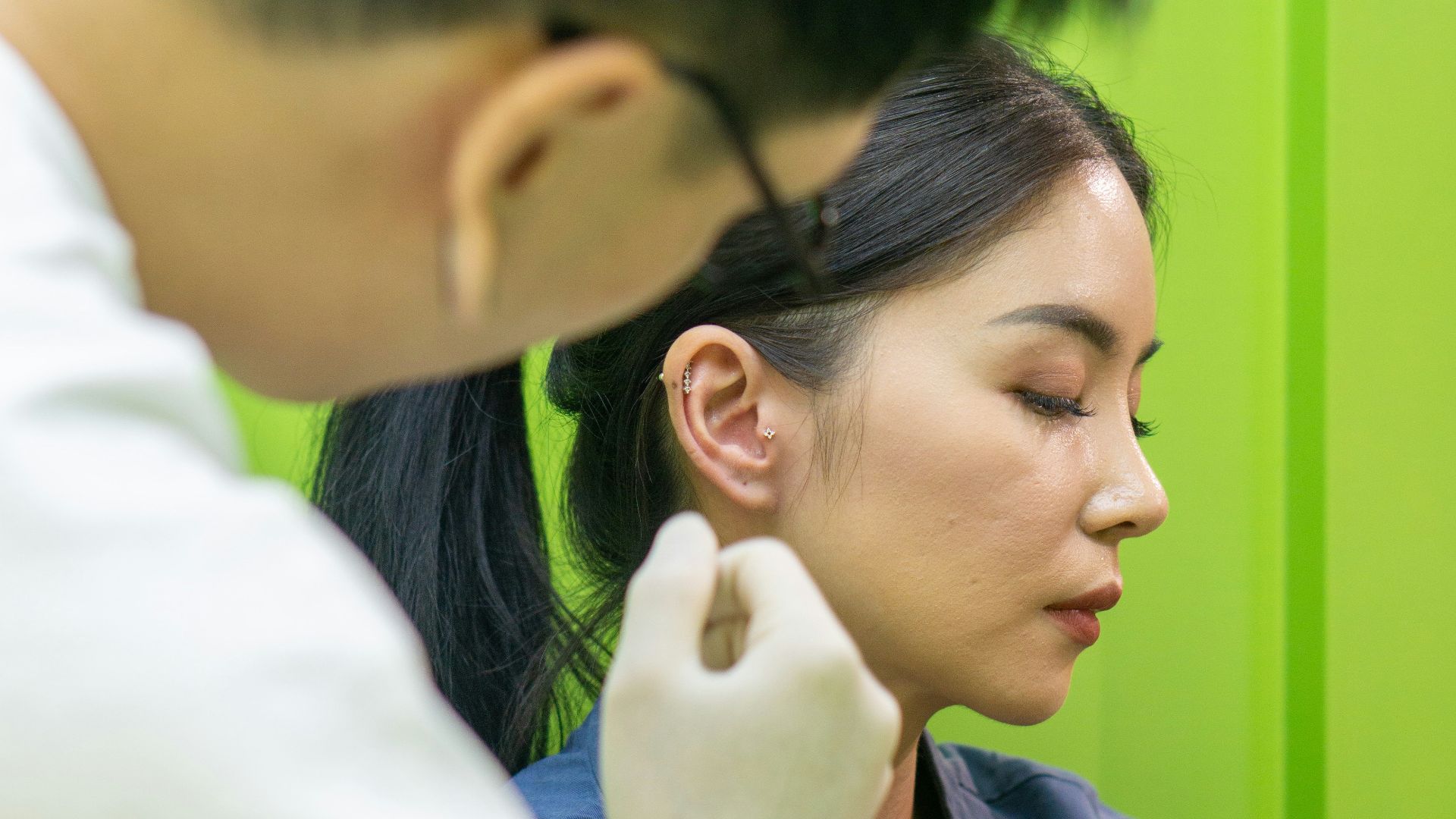 A woman getting her hair done by a man