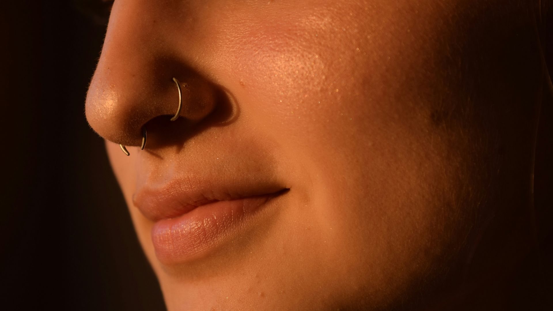 a close up of a woman with a nose piercing