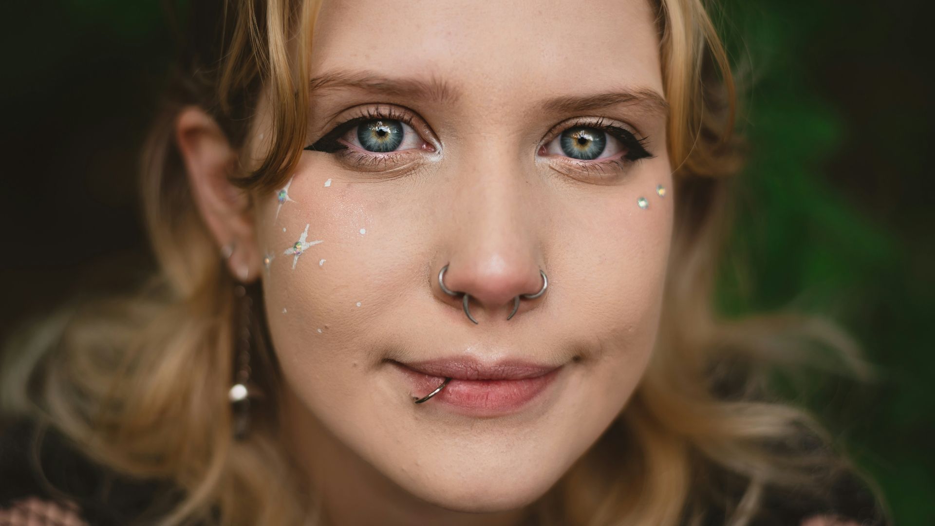 a woman with a nose piercing and a nose ring