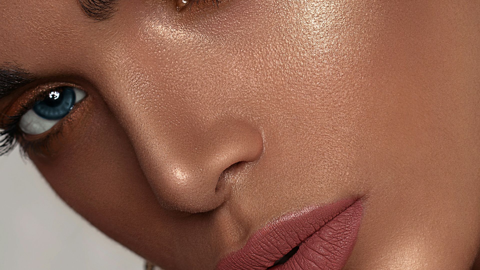 woman with red lipstick and gold hoop earrings