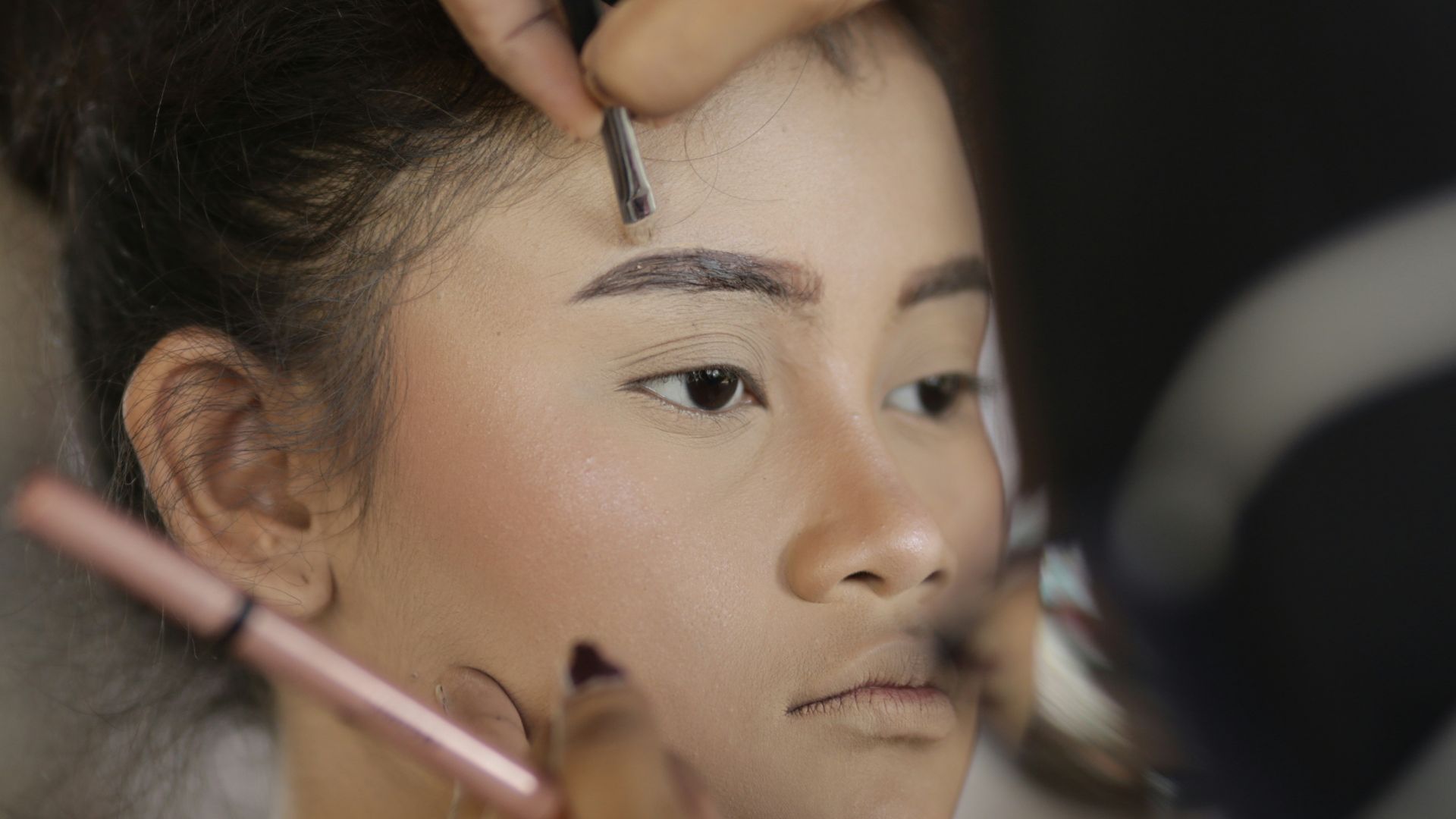 a woman getting her hair done by a professional hair stylist