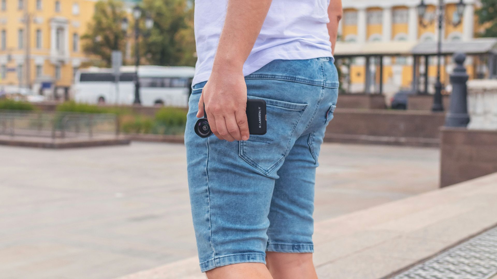 man wearing white shirt and blue denim shorts