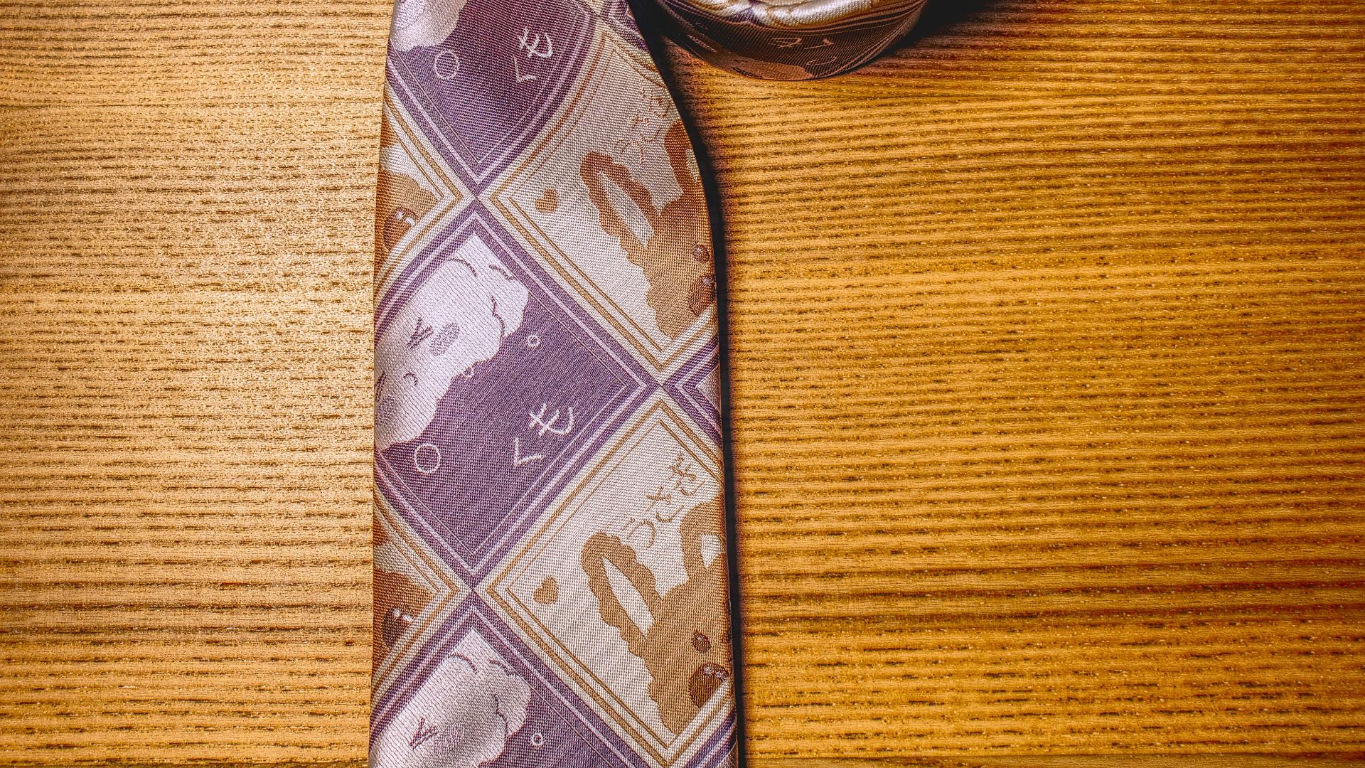 brown and white necktie on brown wooden table