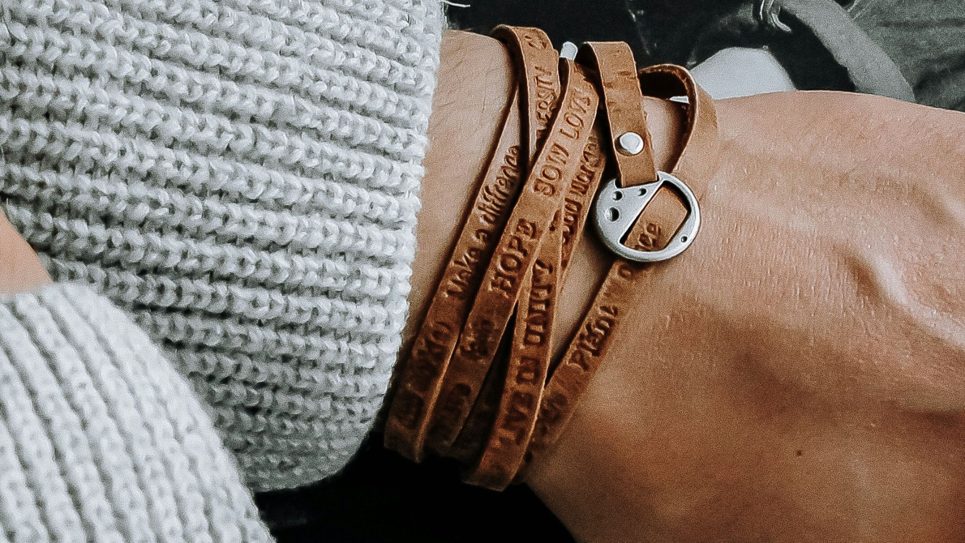 a person holding a black and white striped shirt with a black and white logo on it