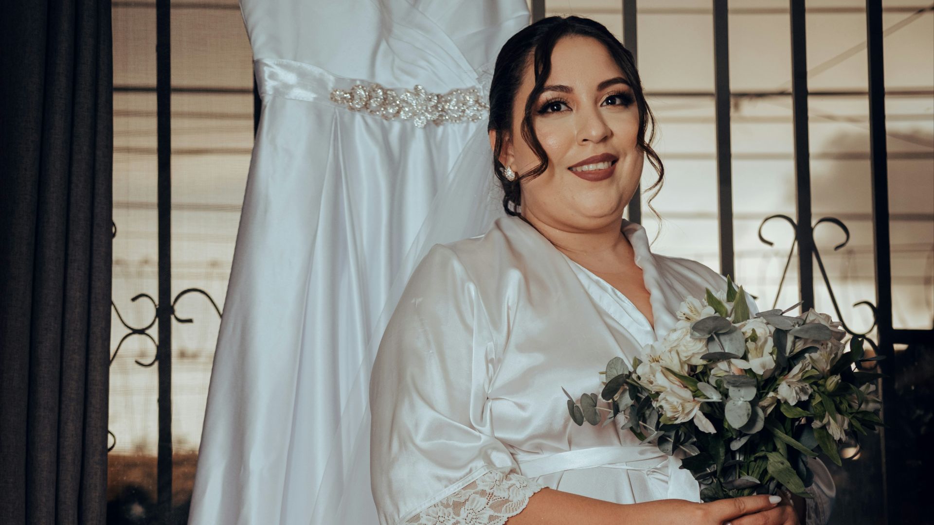 a woman standing in front of a wedding dress