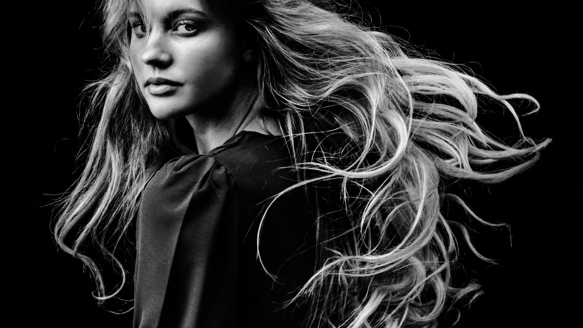 a black and white photo of a woman with long hair