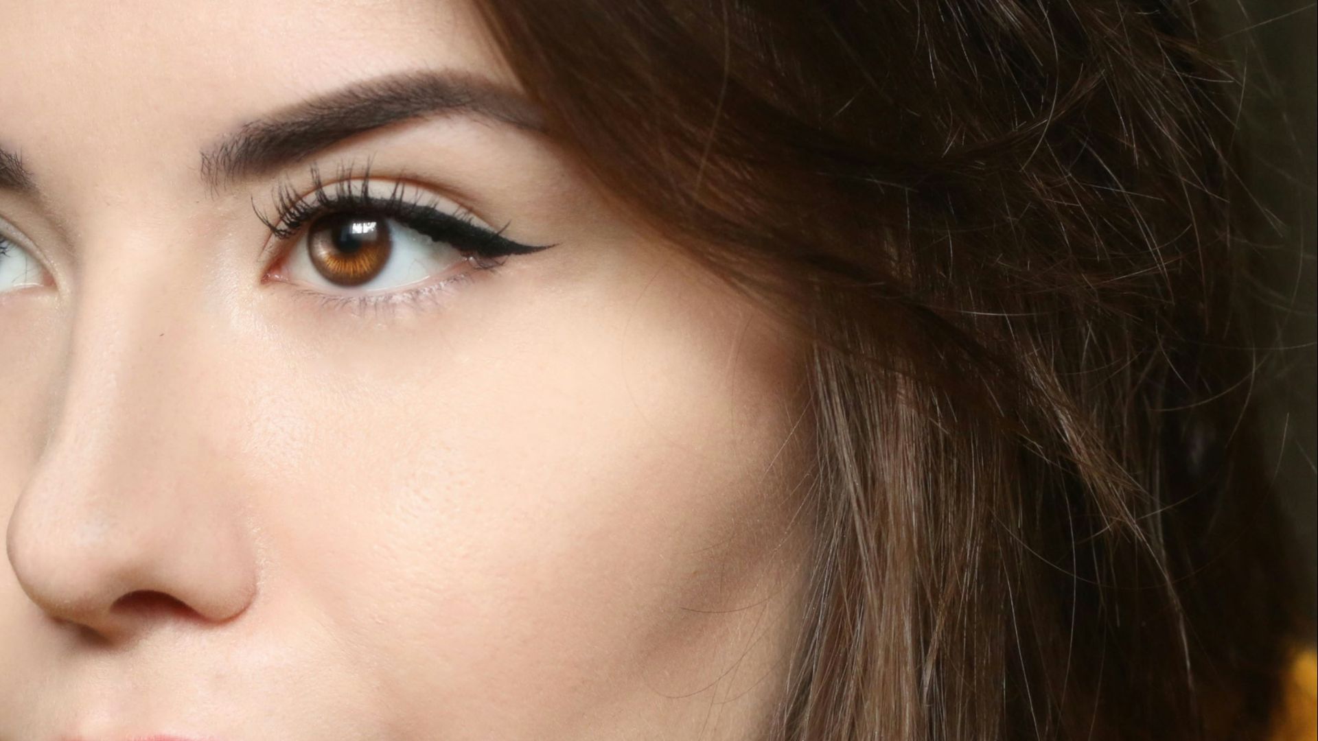 a close up of a person wearing a yellow shirt