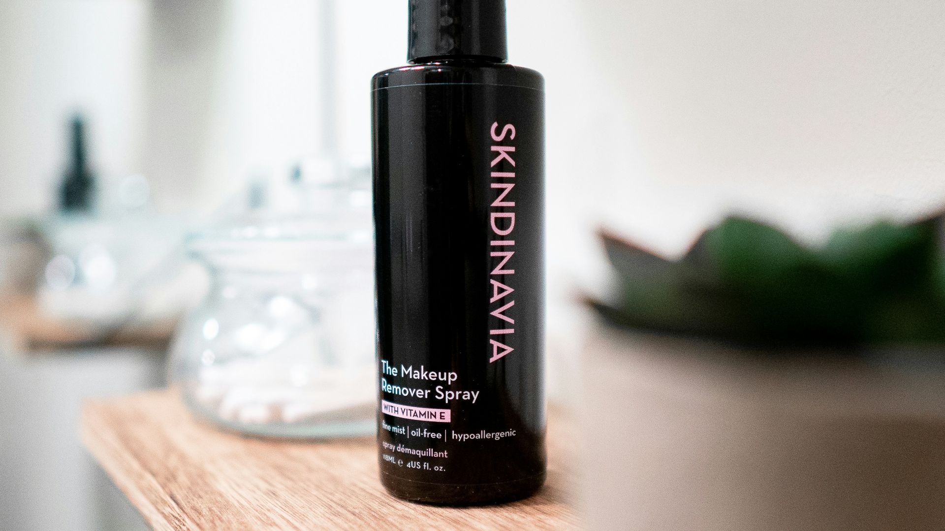 black and red spray bottle on brown wooden table