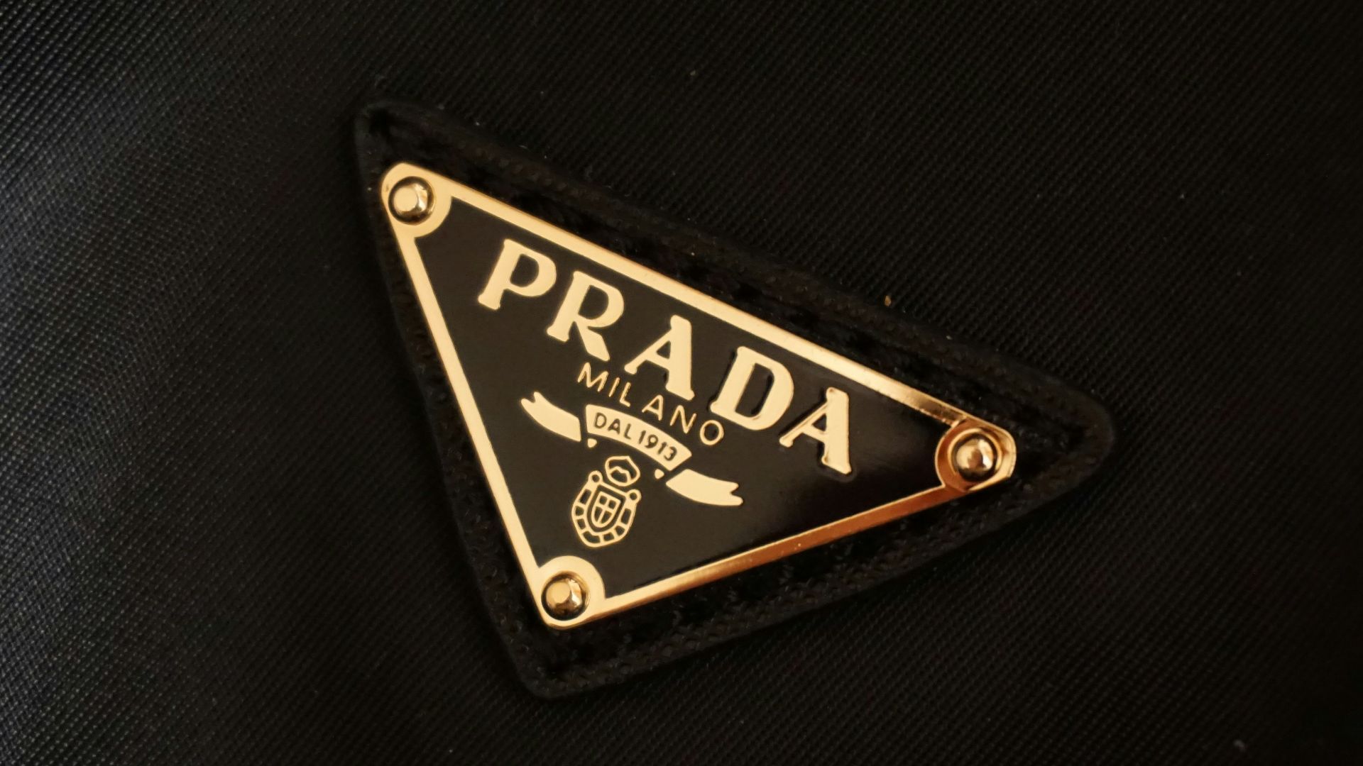 a prada logo on a black jacket