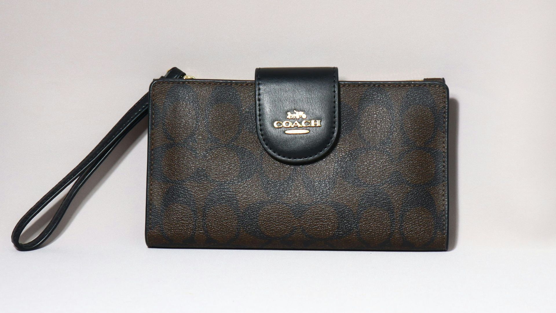 A coach wallet is displayed on a white background.
