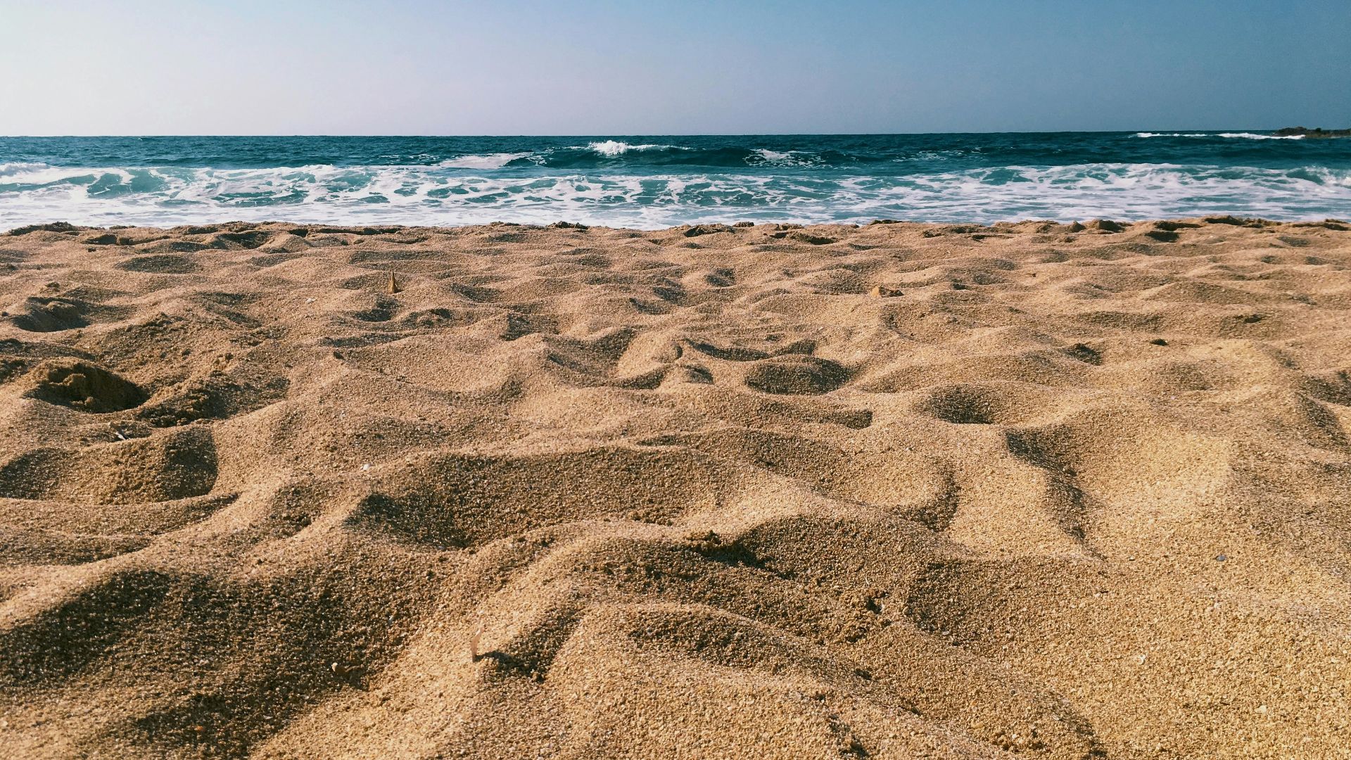brown sands near seashore at daytime