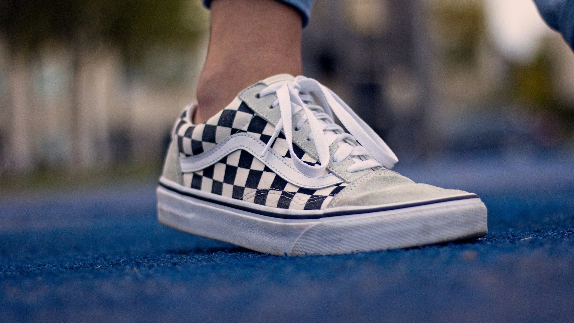 person wearing white and blue nike sneakers