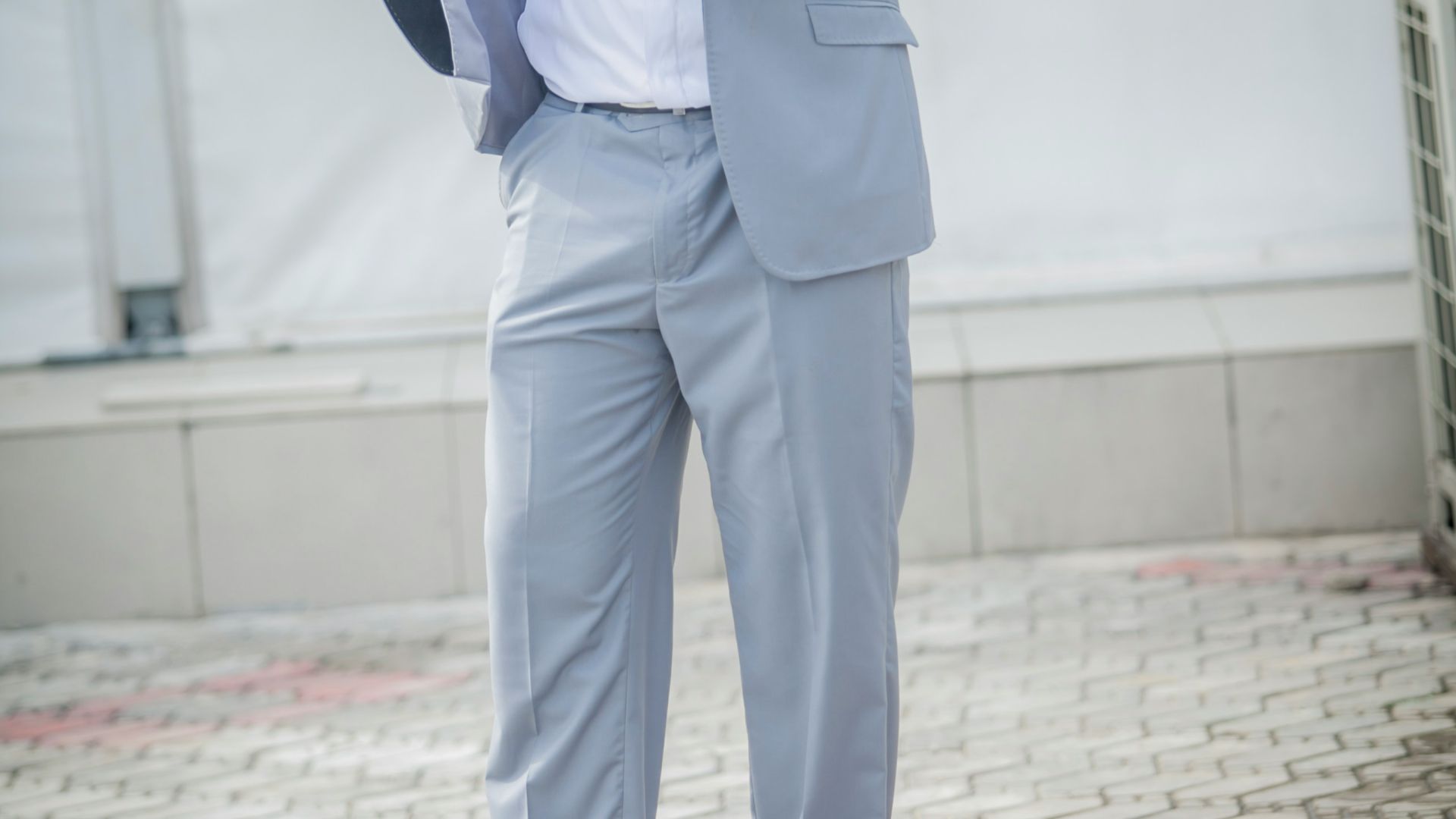 a man in a tuxedo is holding a jacket