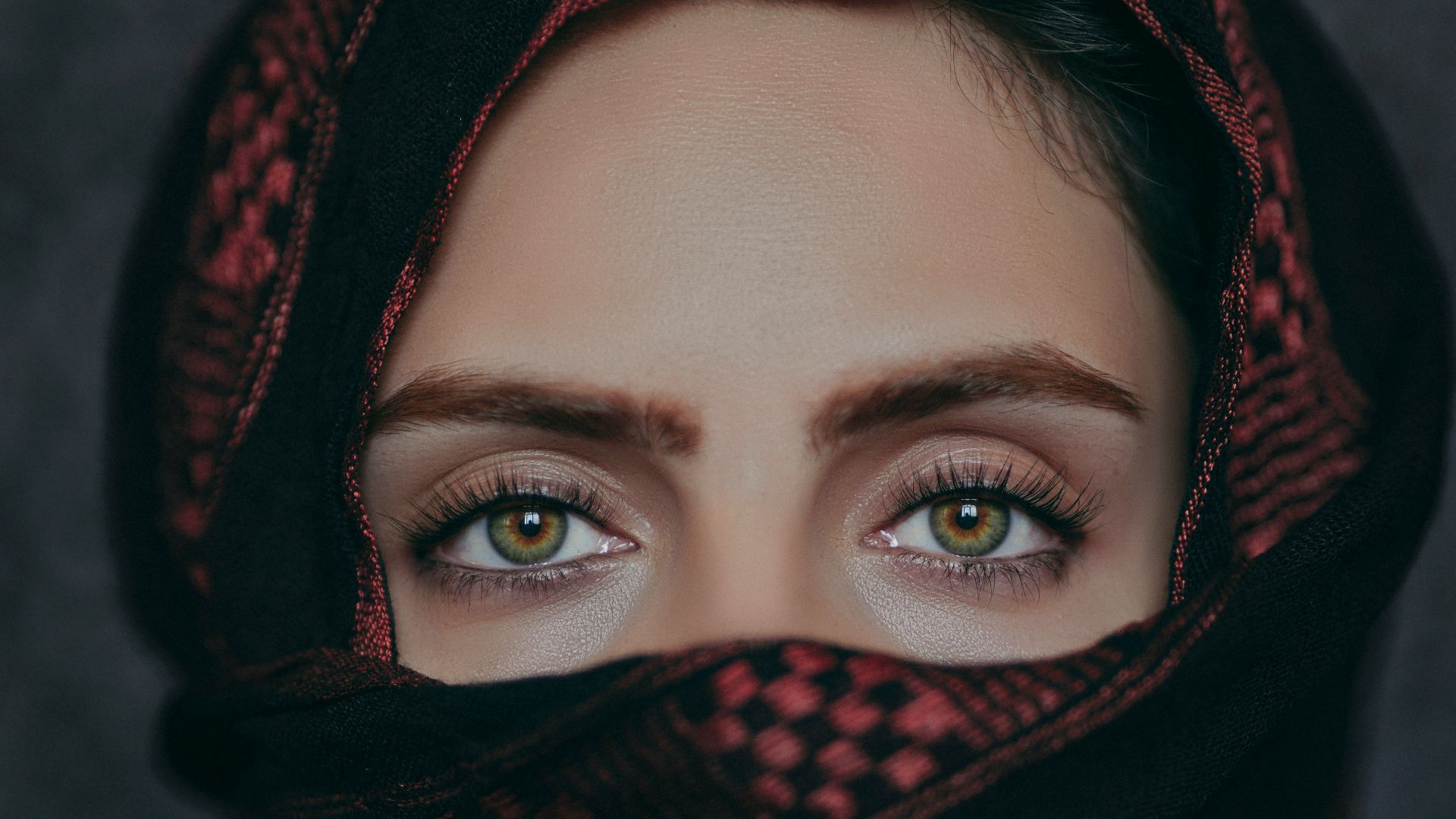 a woman wearing a black and red scarf