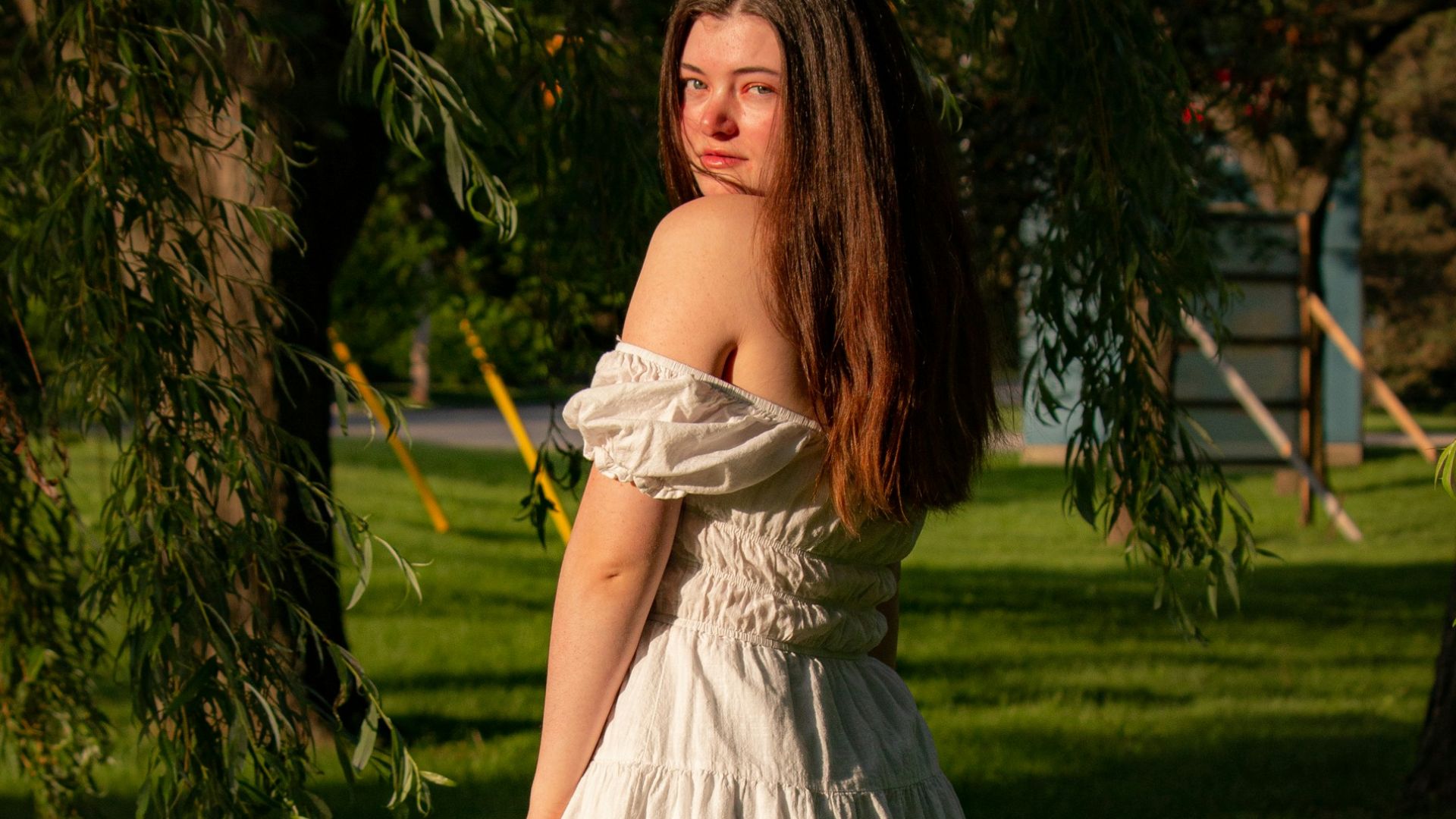a woman in a short dress standing in the grass