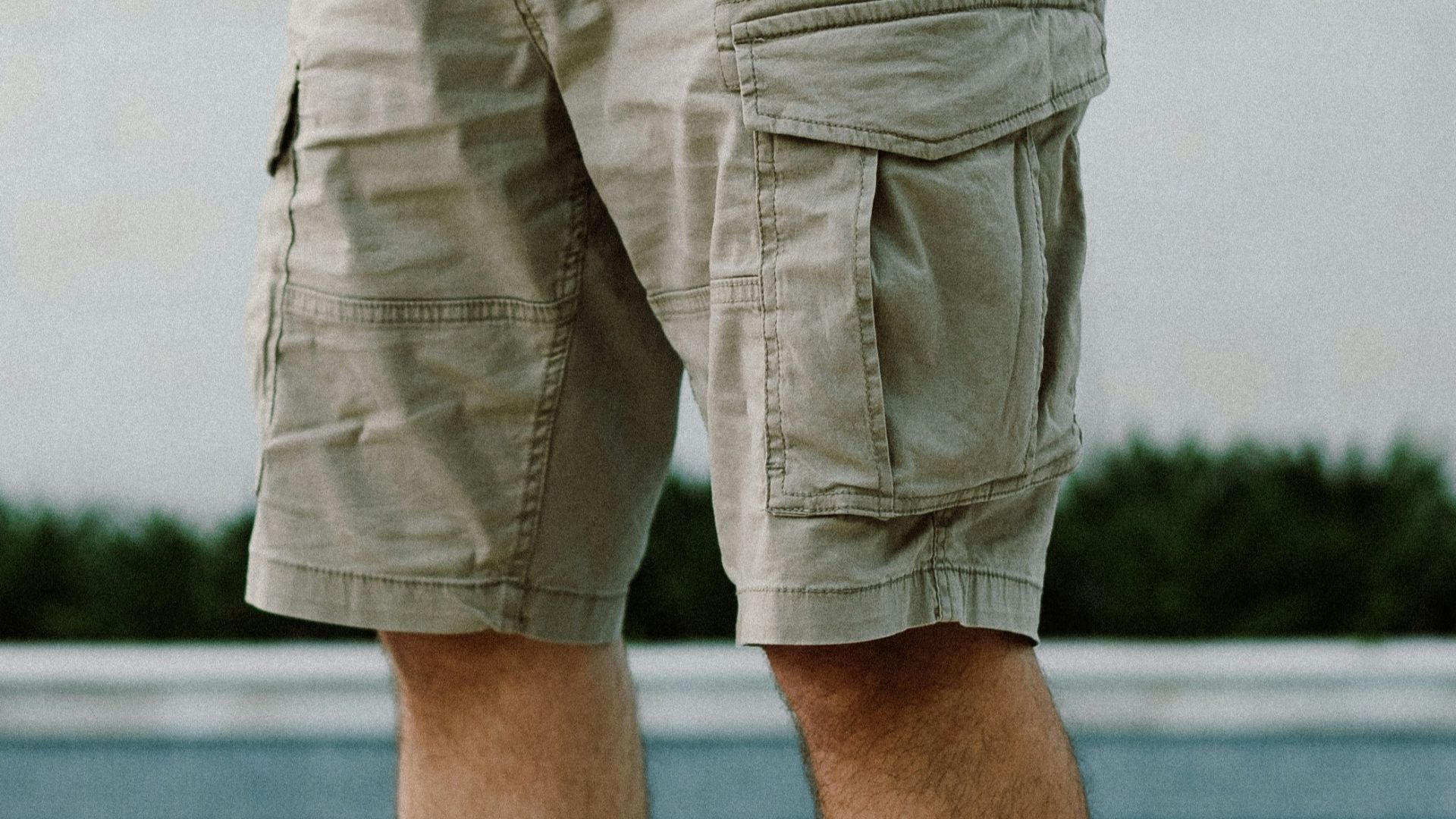 A man standing next to a swimming pool