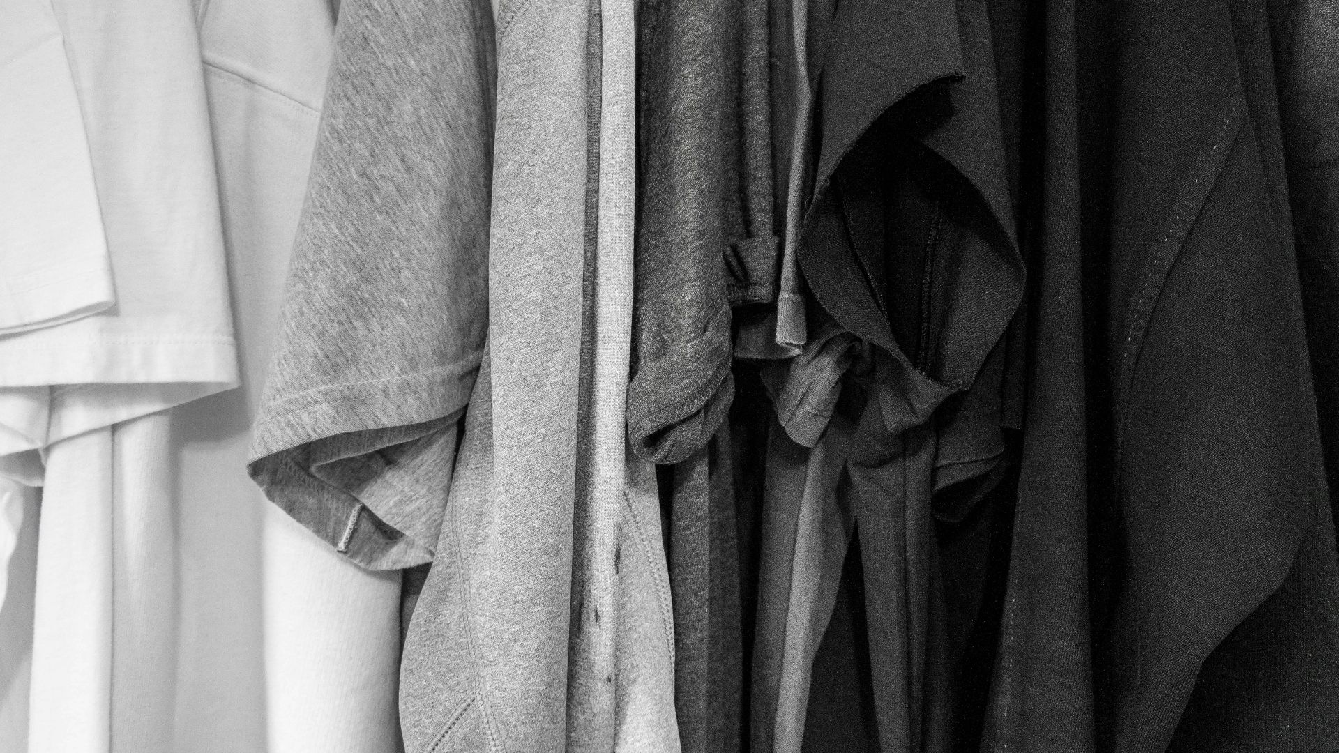 grayscale photography of assorted clothes