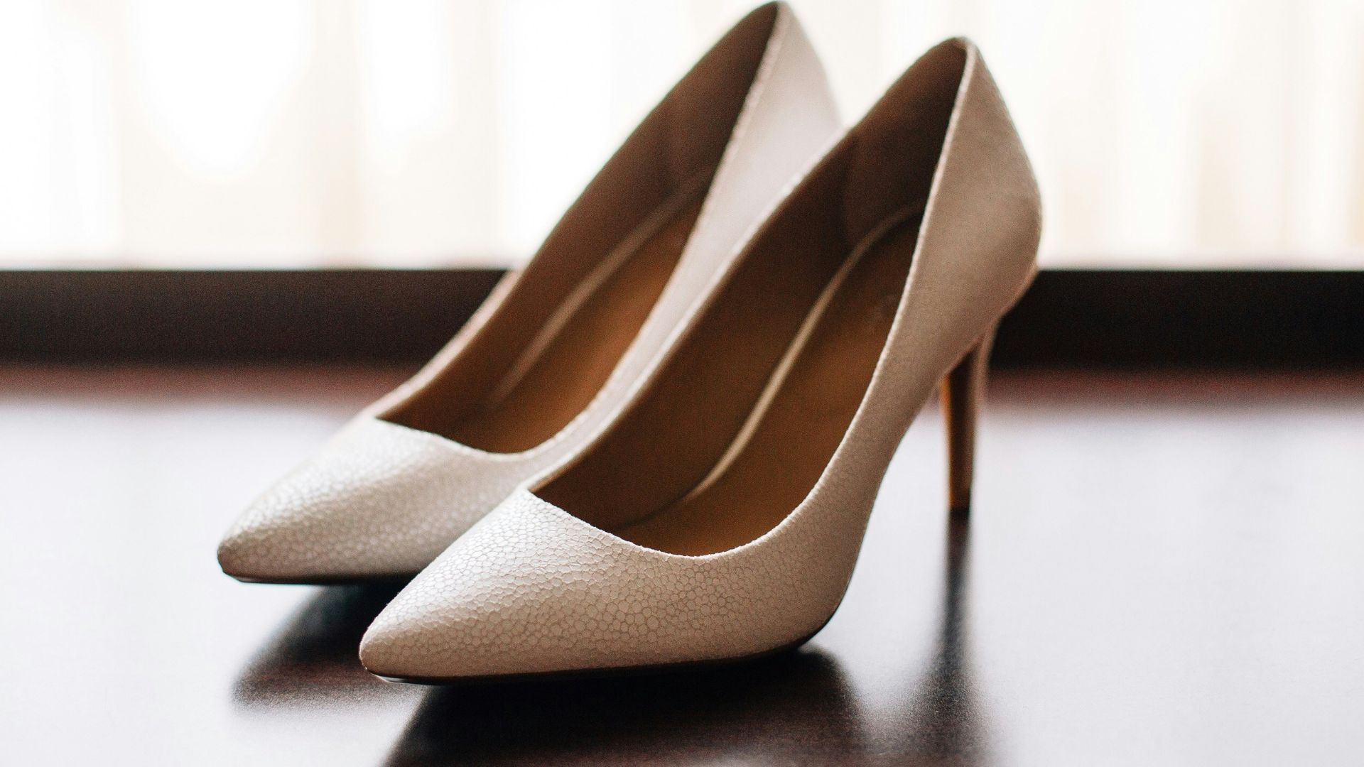 pair of women's brown pointed-toe pumps on board