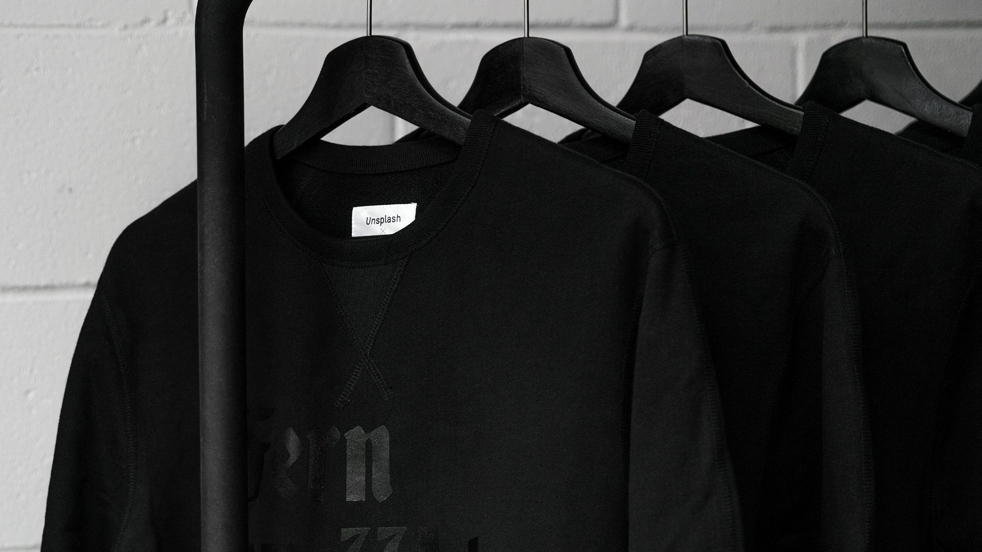black sweatshirts on plastic hangers