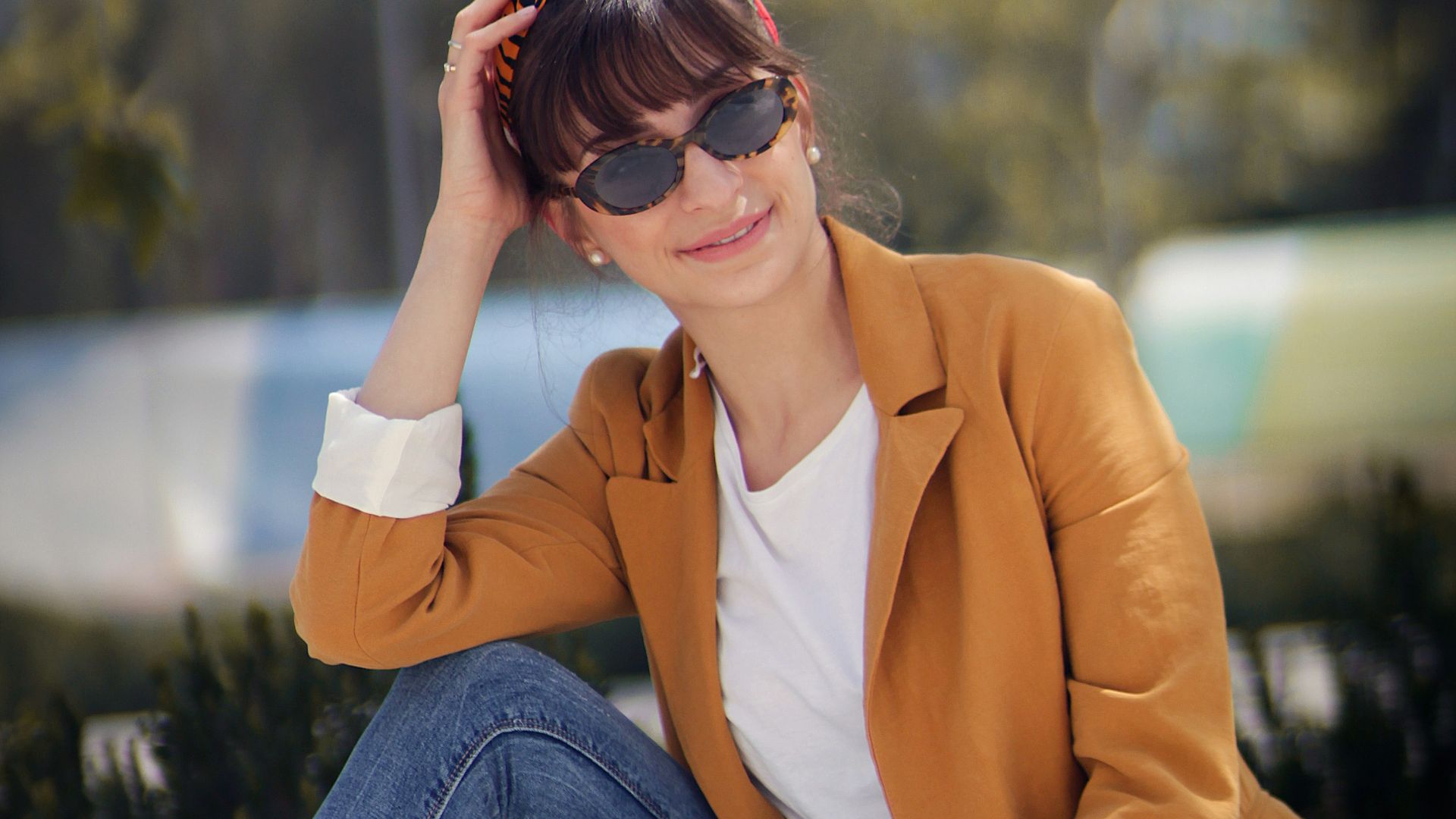 woman sitting on concrete bench near tree