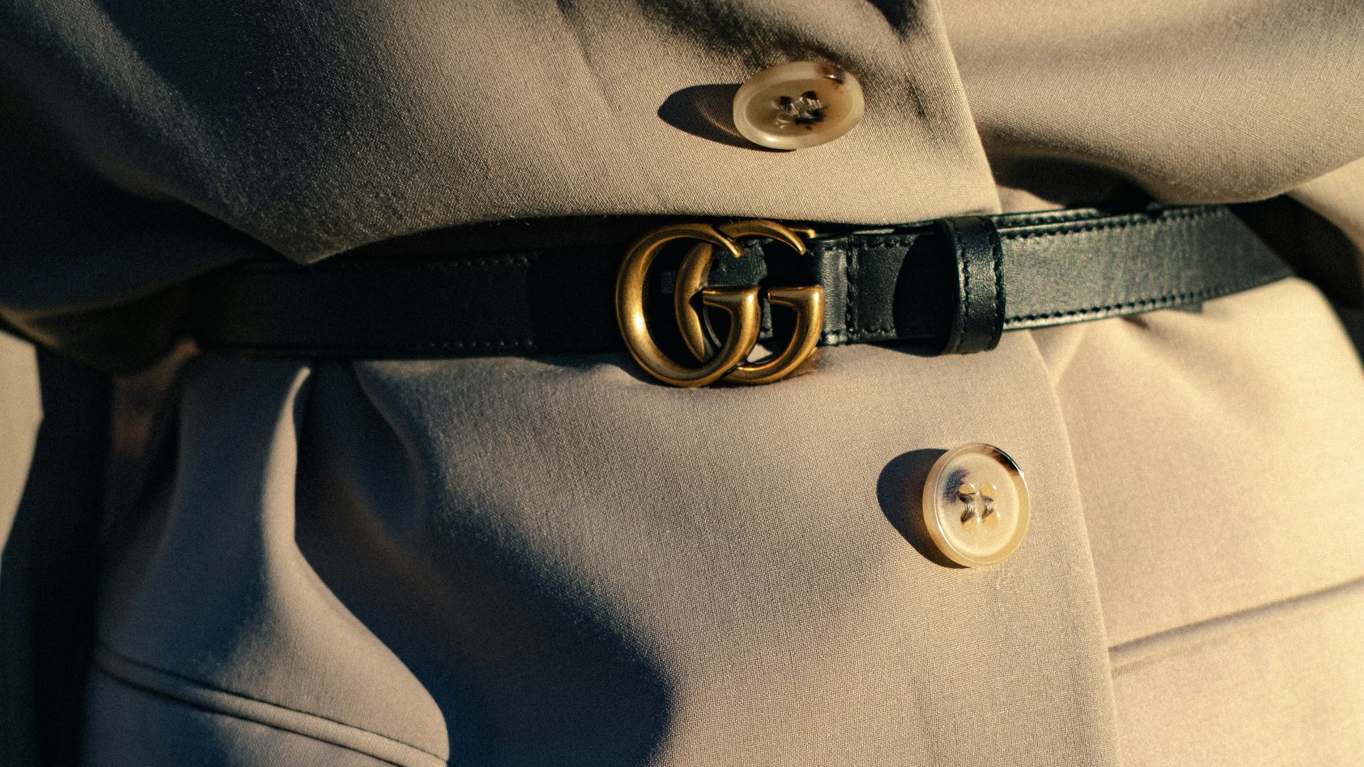 black leather belt on gray textile