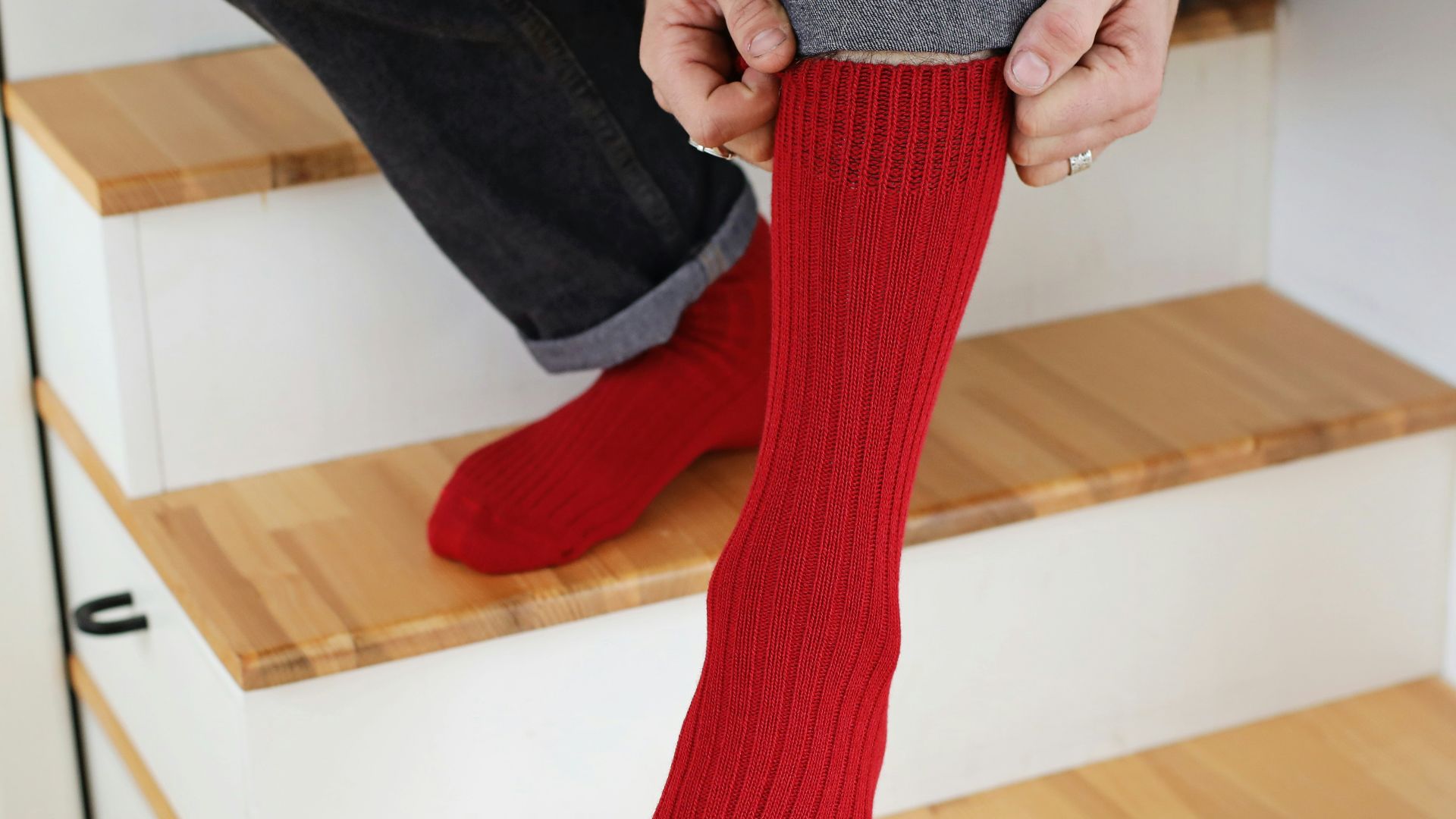 a person sitting on a set of stairs with red socks