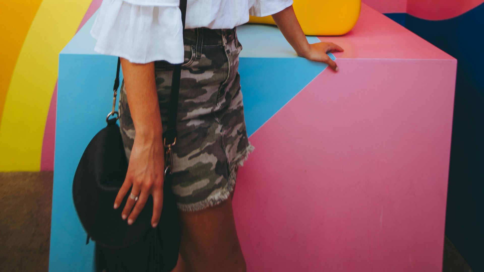 woman watching yellow bear sculpture
