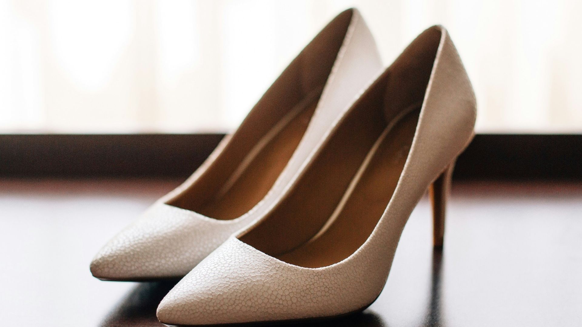 pair of women's brown pointed-toe pumps on board