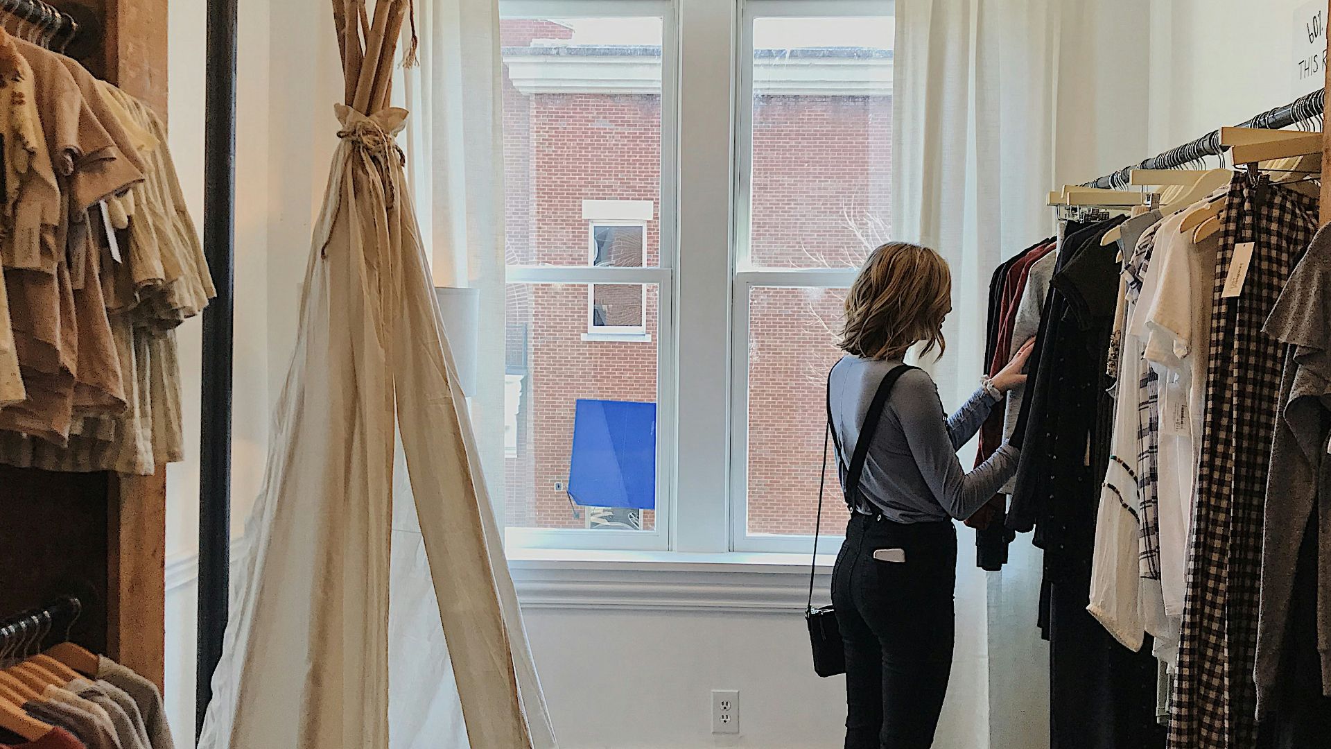 woman standing selecting clothes