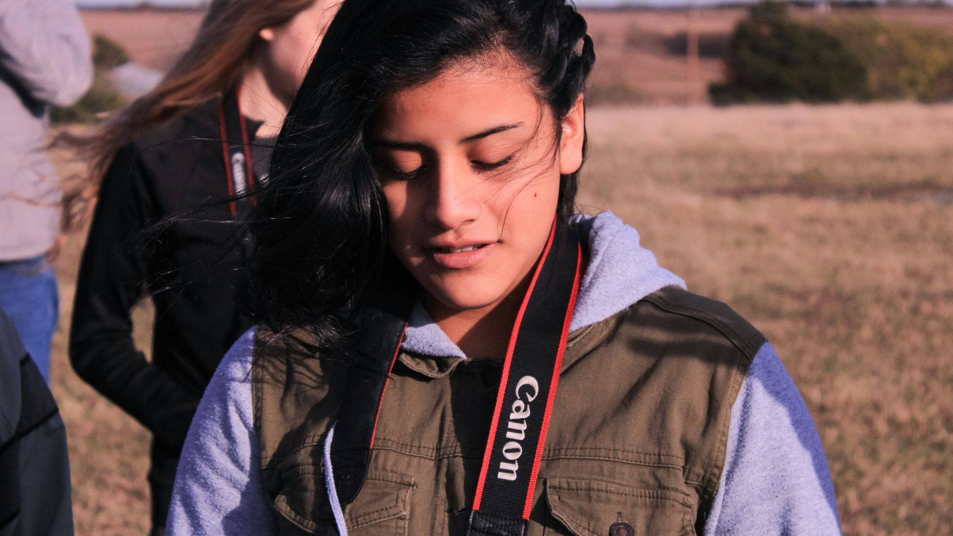 a girl with a camera around her neck