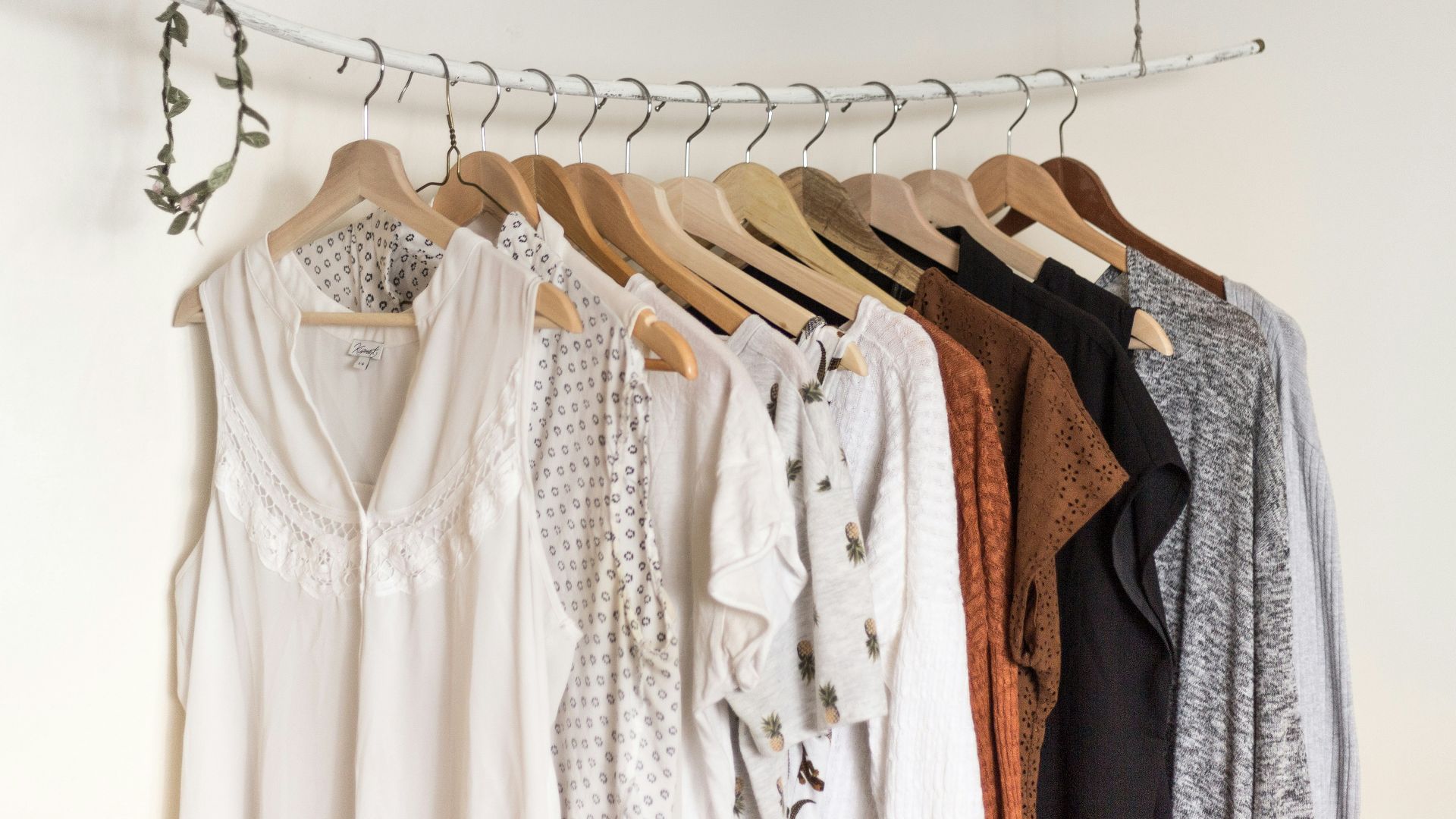assorted clothes in wooden hangers