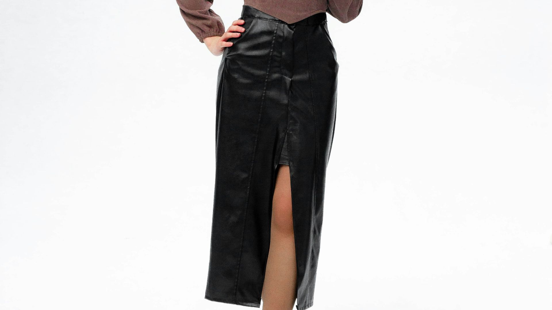 a woman in a brown top and black leather skirt