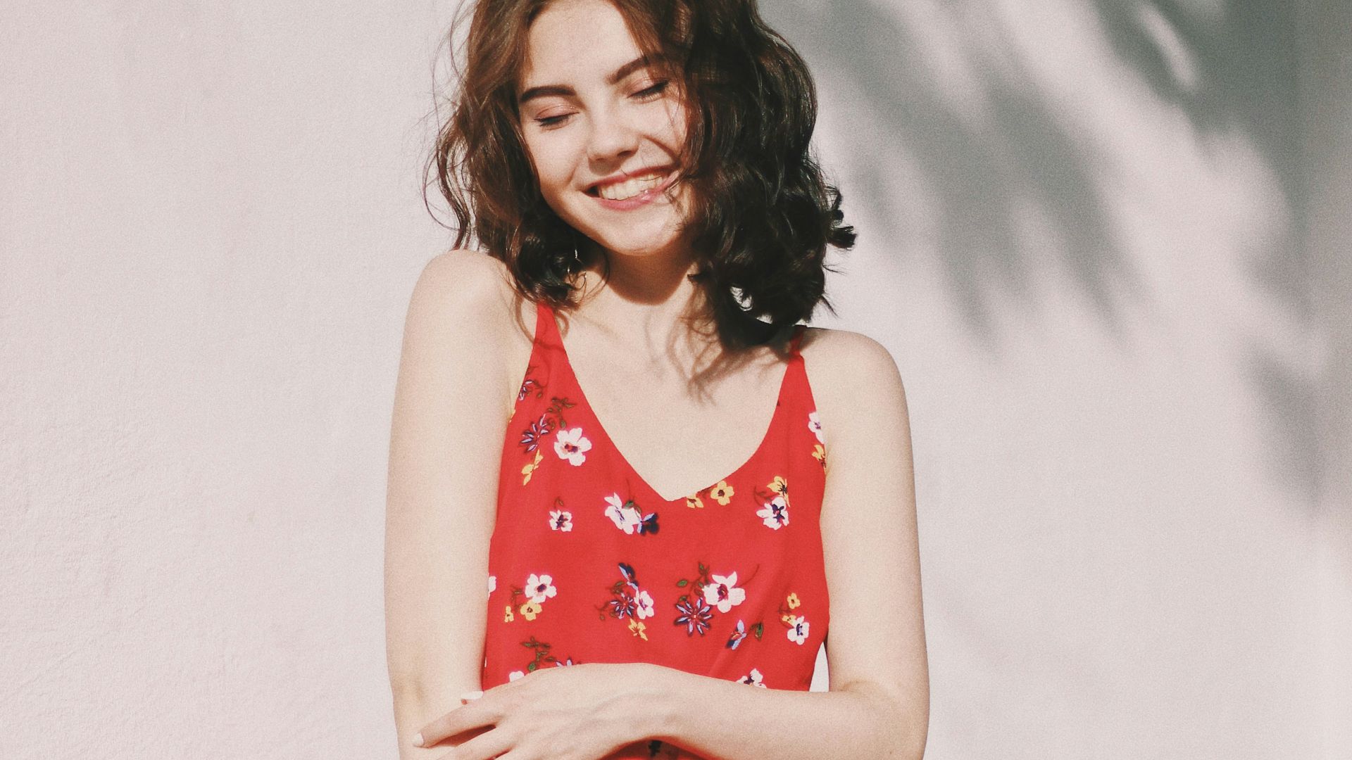 woman standing in front of white wall