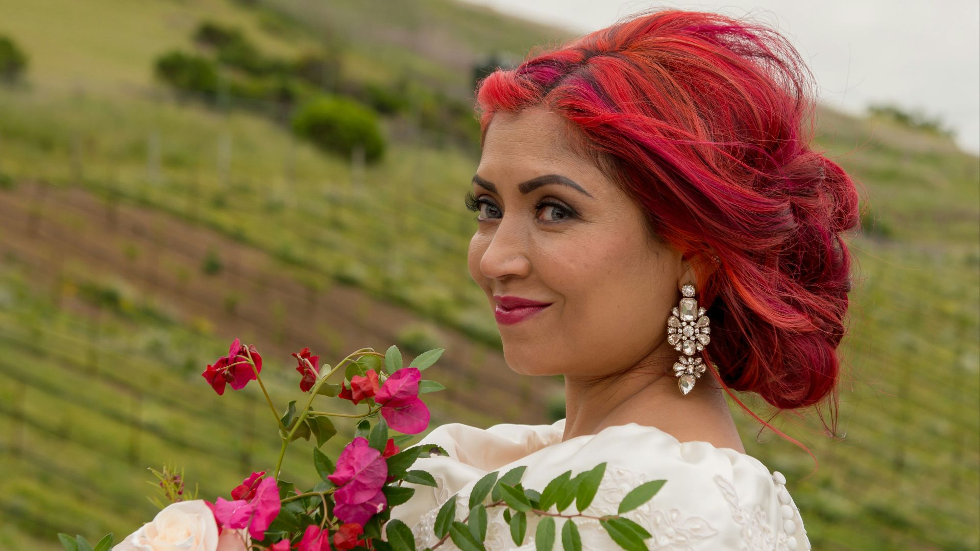 A woman in a wedding dress holding a bouquet of flowers