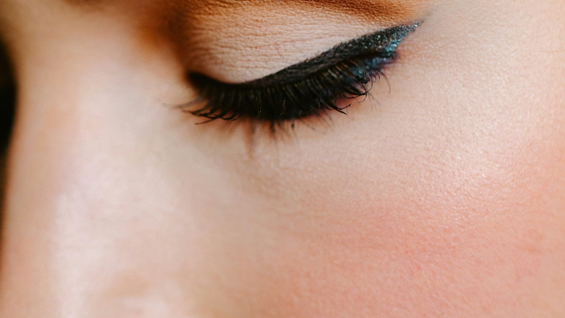 woman with red lipstick and black mascara