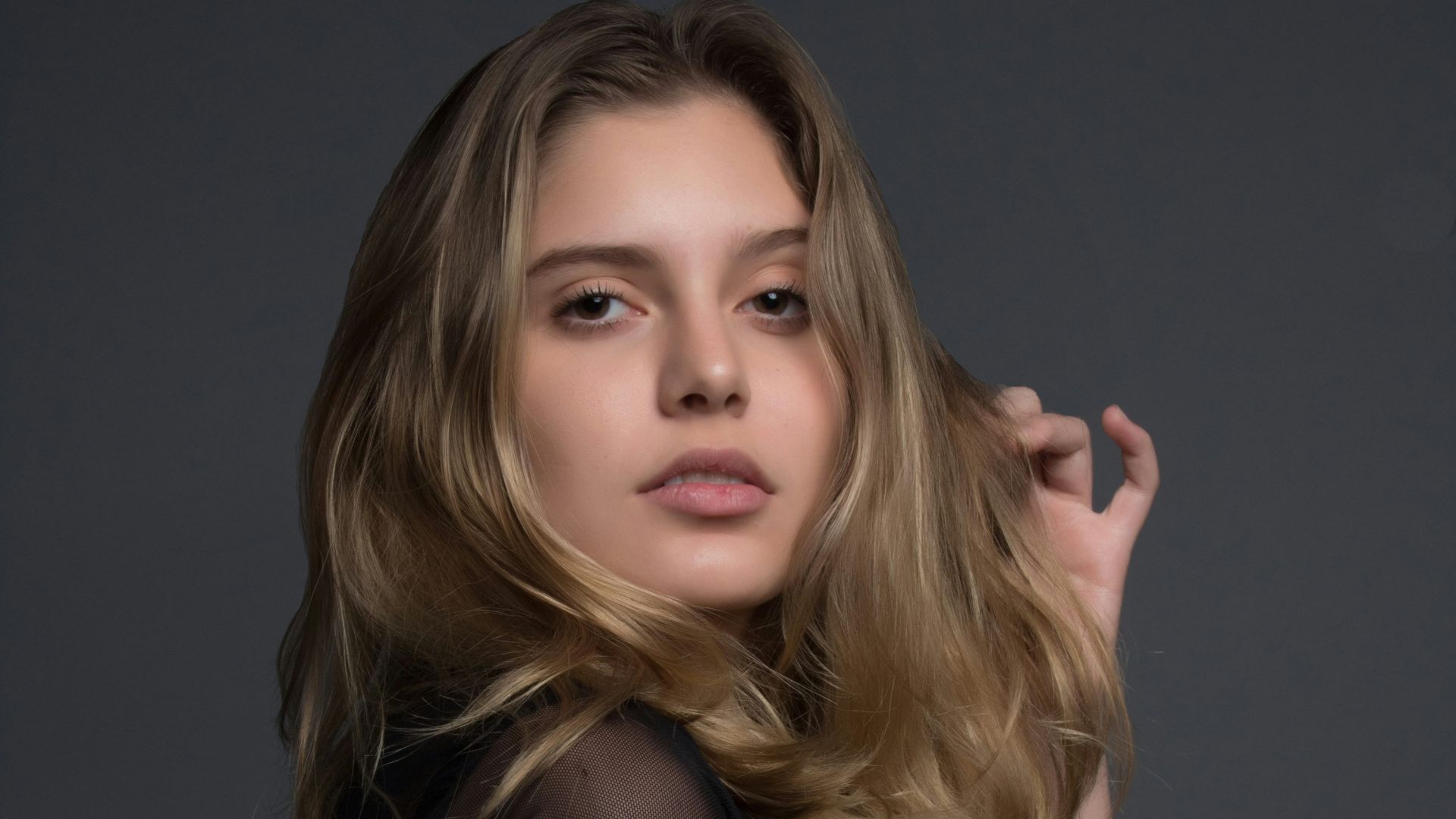 woman holding heft long blonde hair