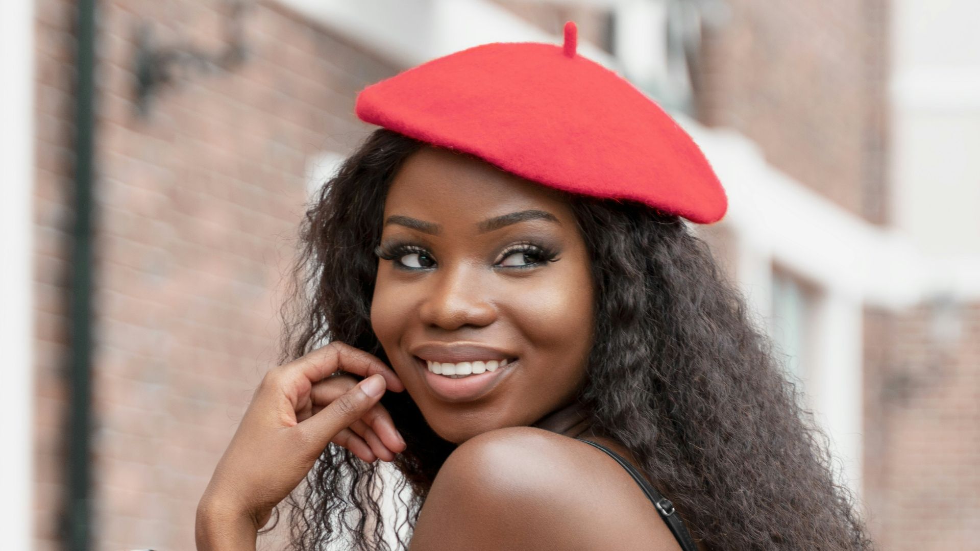 woman in black spaghetti strap dress holding coca cola bottle