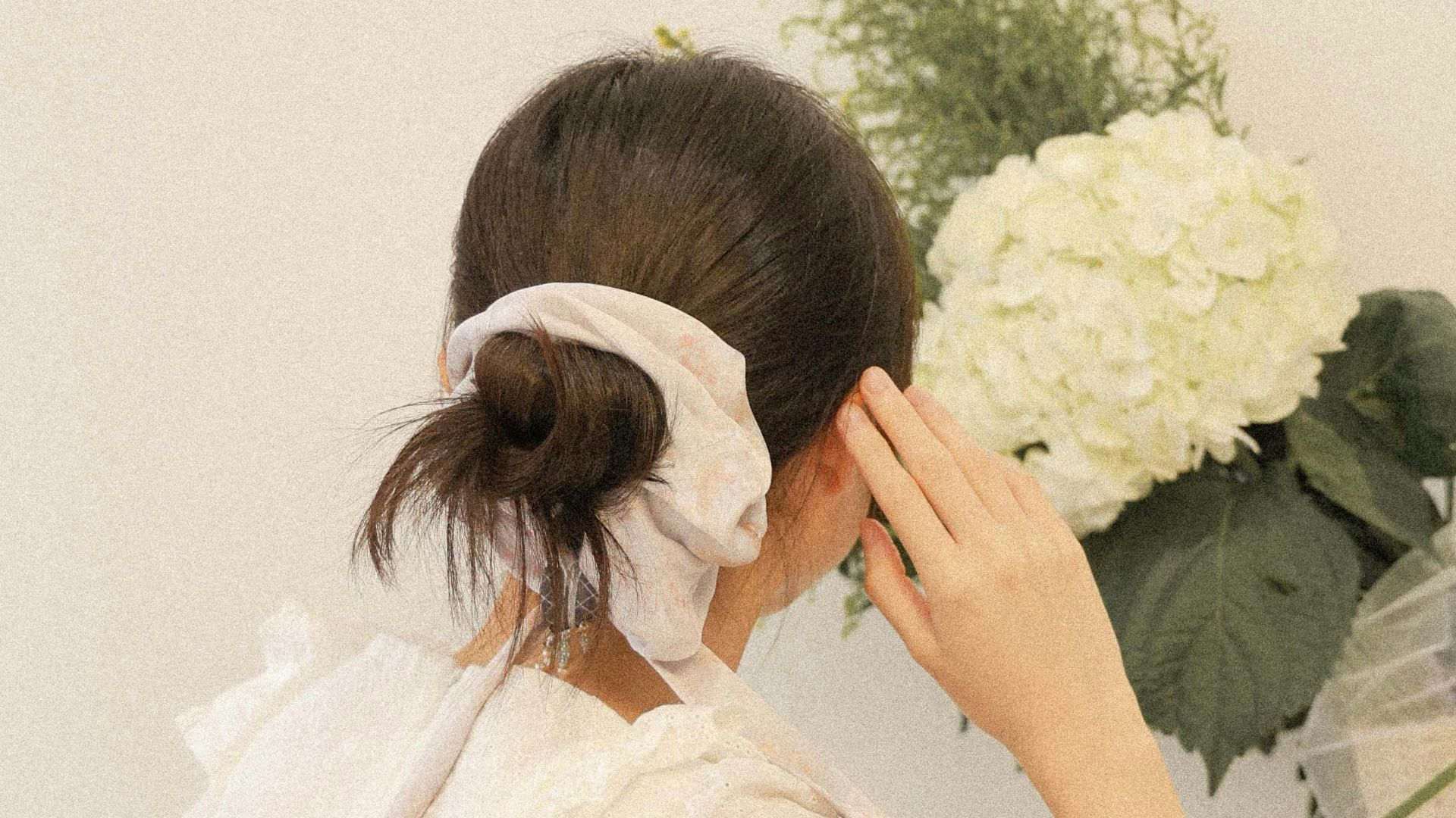 a woman in a white dress and a bouquet of flowers